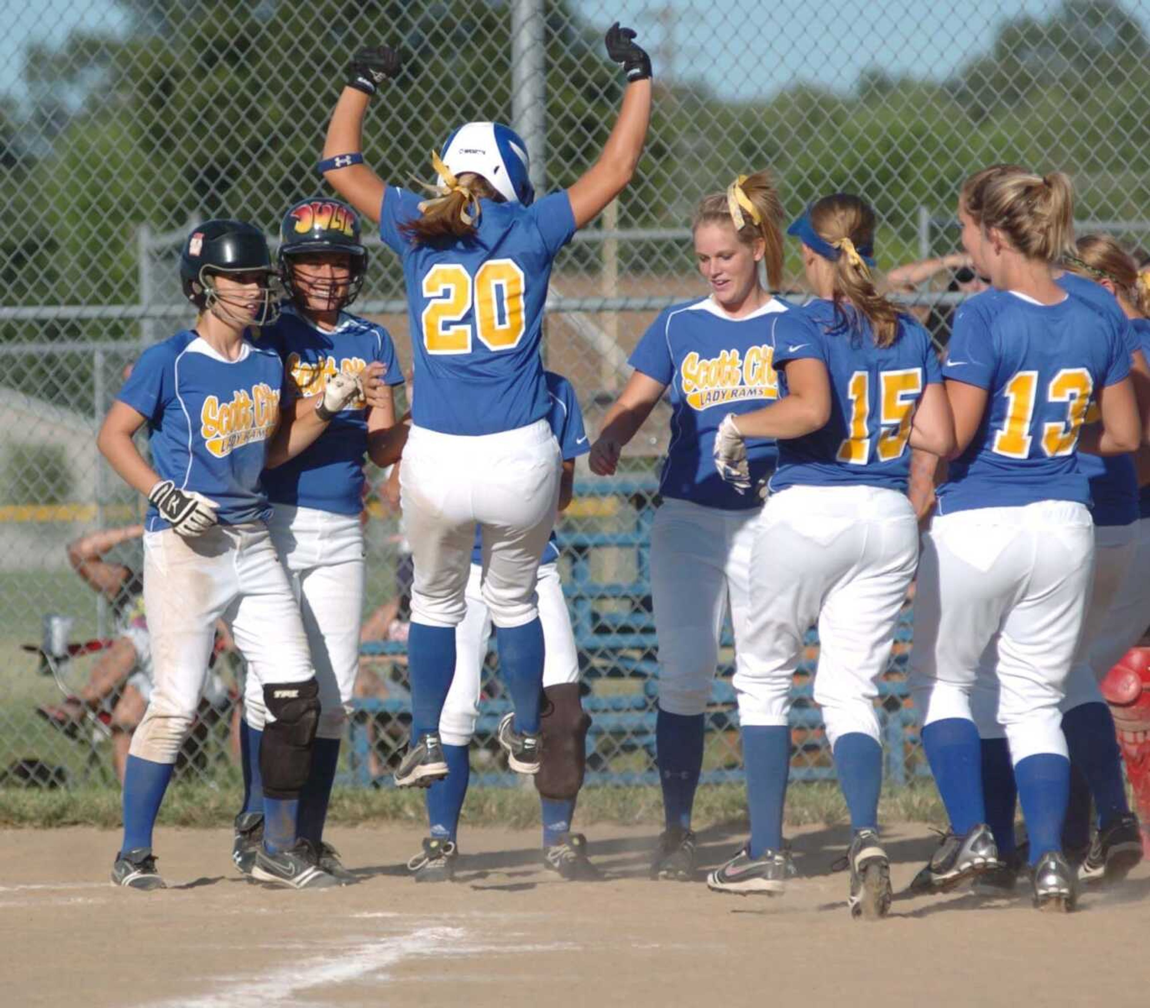 Scott City's Alexis Spriggs (20) is met at home plate by her teammates after hitting a grand slam during Thursday's game against visiting Chaffee. (BRENT SHIPMAN ~ Sikeston Standard Democrat)