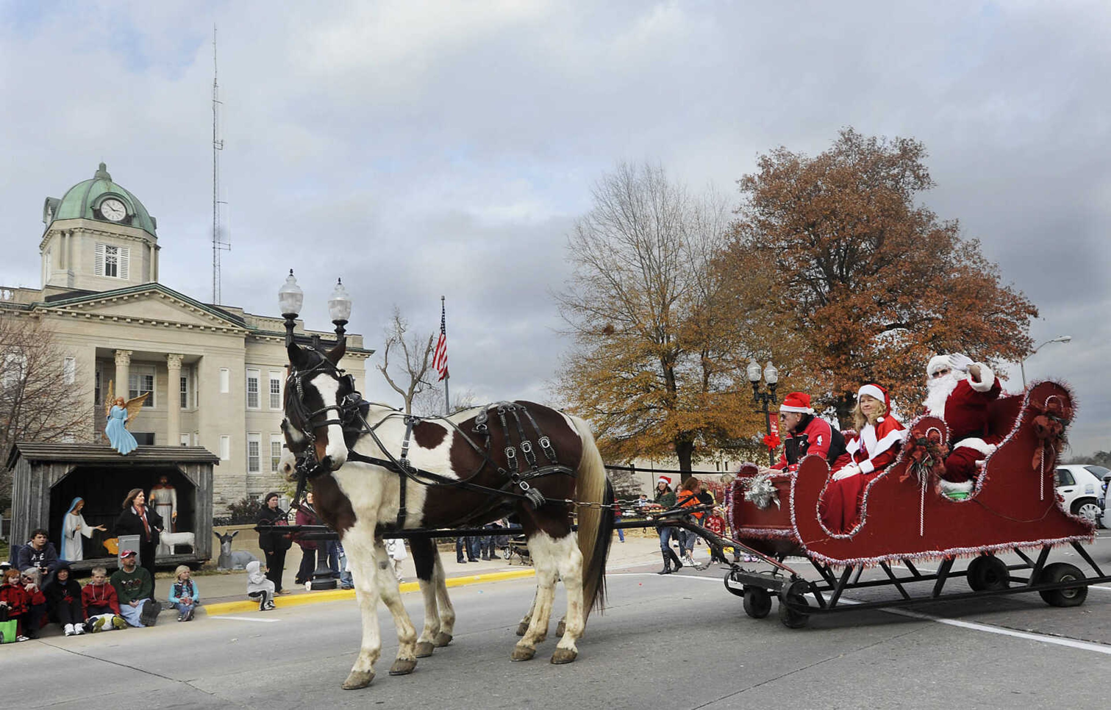 Santa Clause waves to the crowd as he passes by the Cape Girardeau County Courthouse during the Jackson Jaycee Foundation Christmas Parade Saturday, Dec. 1, in Jackson.