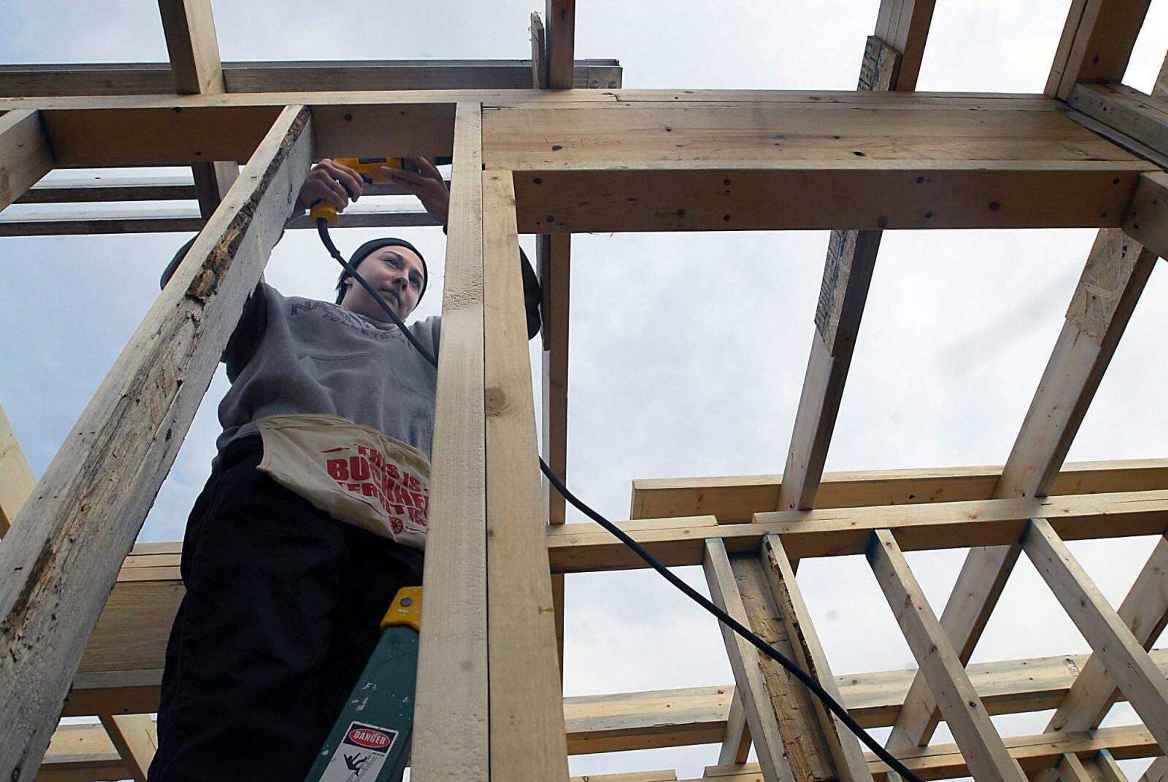 KIT DOYLE ~ kdoyle@semissourian.com
Nineteen-year-old volunteer Jessica Ibendahl screws in ceiling beams at the Habitat for Humanity home being built in the Alumni Center parking lot Wednesday, March 11, 2009, in Cape Girardeau.