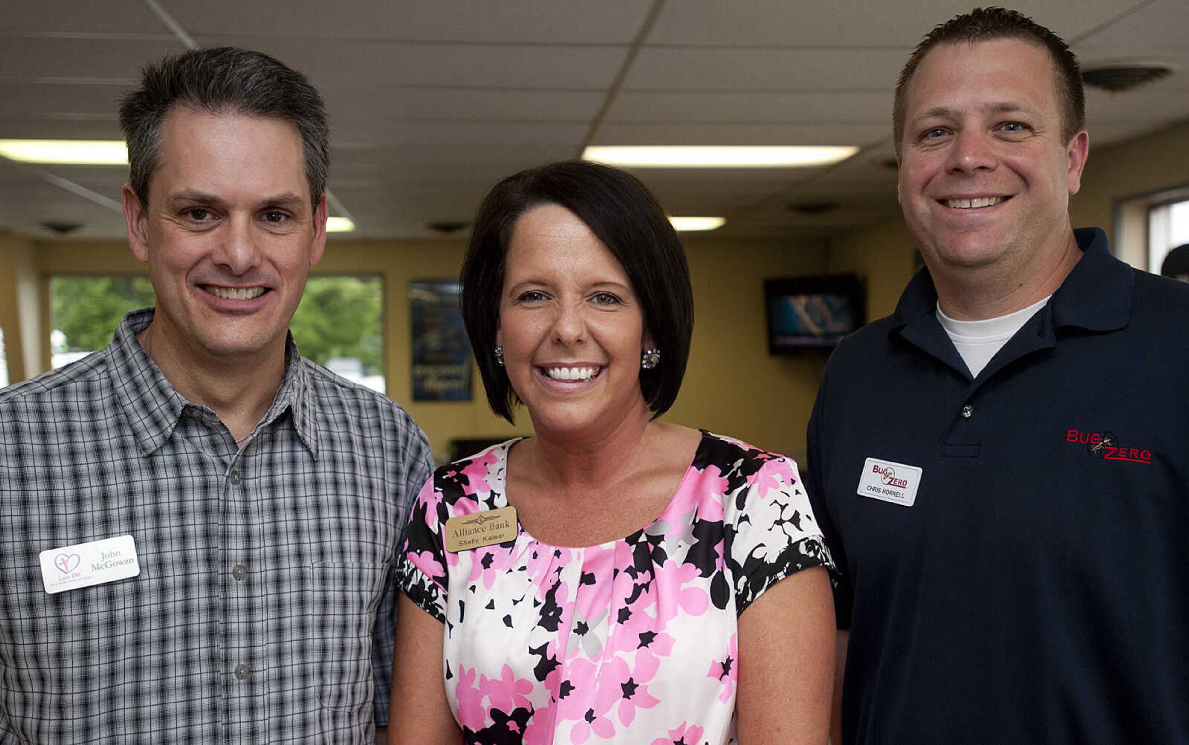 John McGowan, left, Love Inc., Shelly Kaiser, Alliance Bank, and Chris Horrell, Bug Zero, during the Jackson Area Chamber of Commerce's After Hours event Tuesday, May 13,  at First Auto Credit in Jackson, Mo.