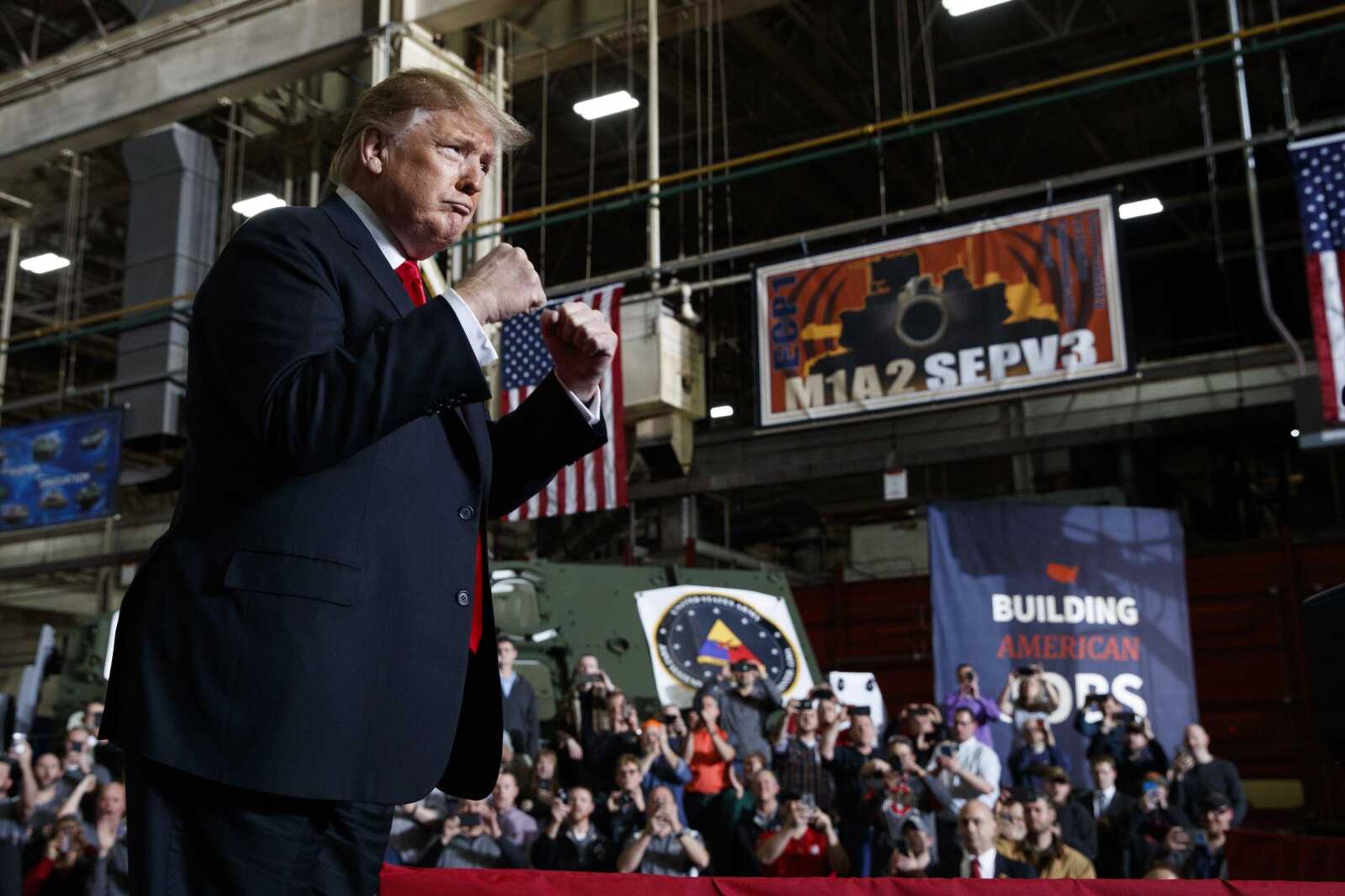 President Donald Trump pumps his fists as he arrives to deliver remarks at the Lima Army Tank Plant, Wednesday in Lima, Ohio.