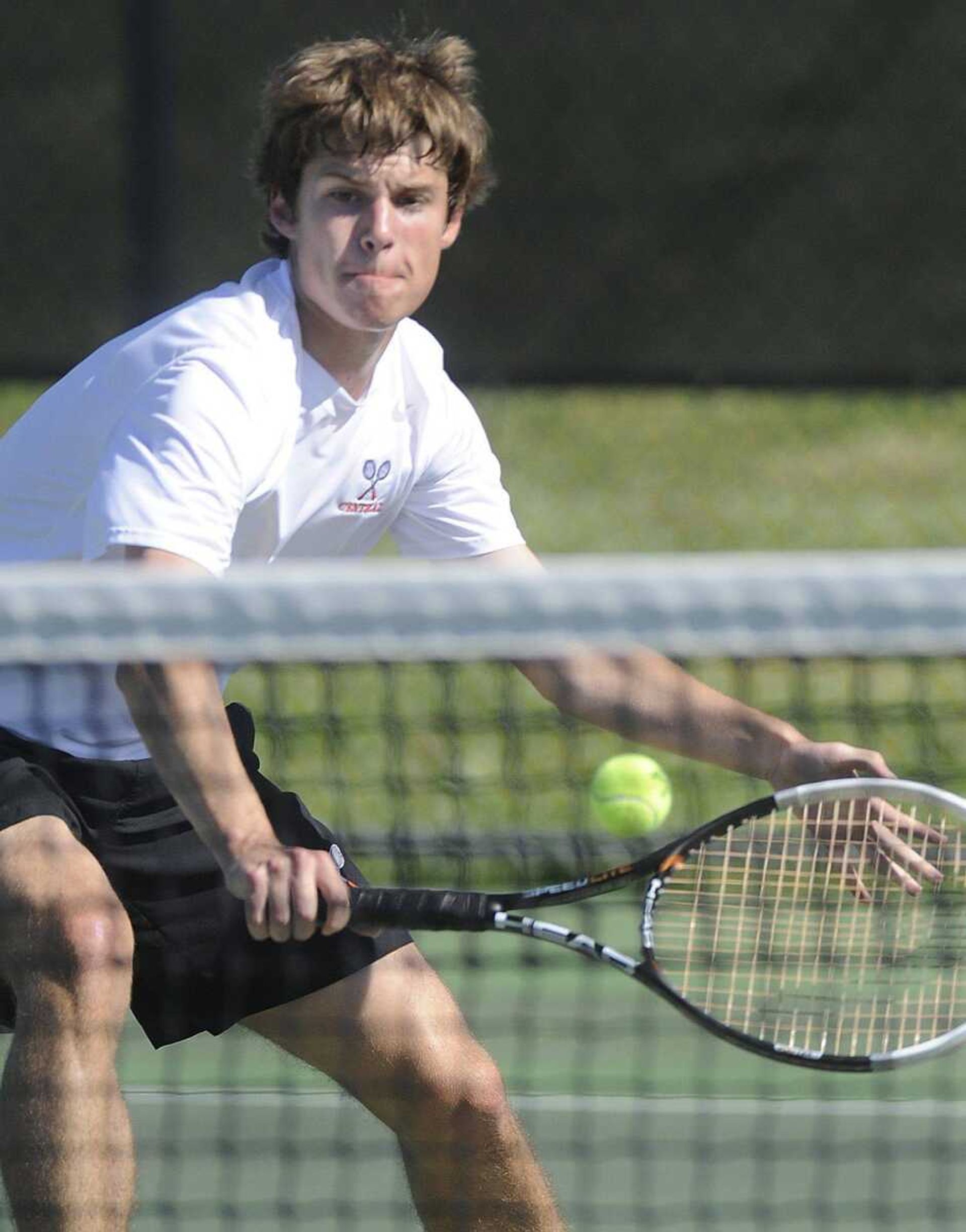 Central's Caleb Strickland hits a backhand at the net in singles against Farmington in the Class 2 District 1 semifinal match Tuesday, May 7, 2013 at Central High School. (Fred Lynch)