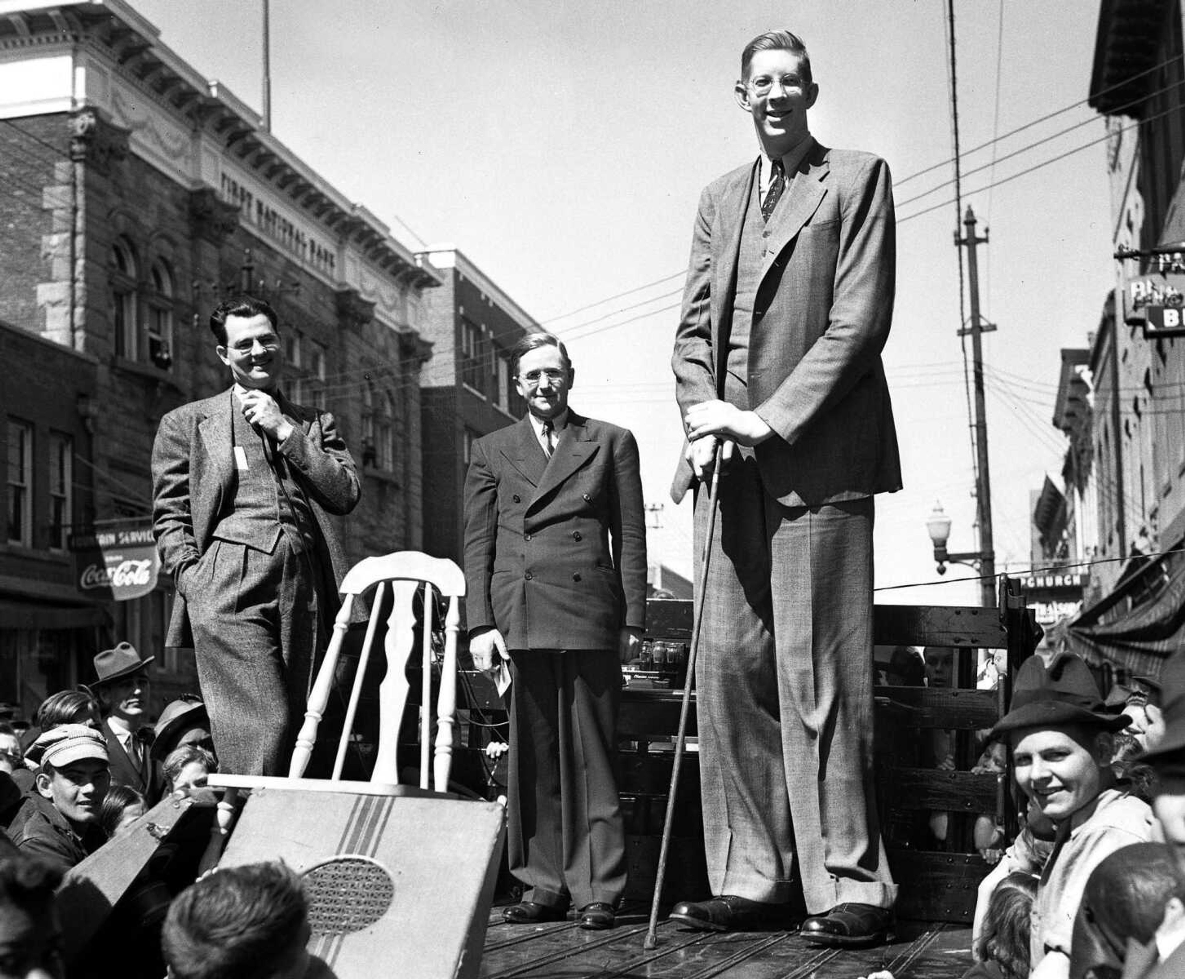 Several hundred people, mostly children, blocked Main Street in Cape Girardeau on March 21, 1939, to get a glimpse of Robert Wadlow, the "Alton, Ill., Giant." Wadlow was about 21 when he came to Cape Girardeau as the guest of a local shoe store. At the time he stood 8 feet, 8 1/4 inches tall and wore size 37 shoes.
(Photo by G.D. "Frony" Fronabarger, Cape Girardeau Southeast Missourian)