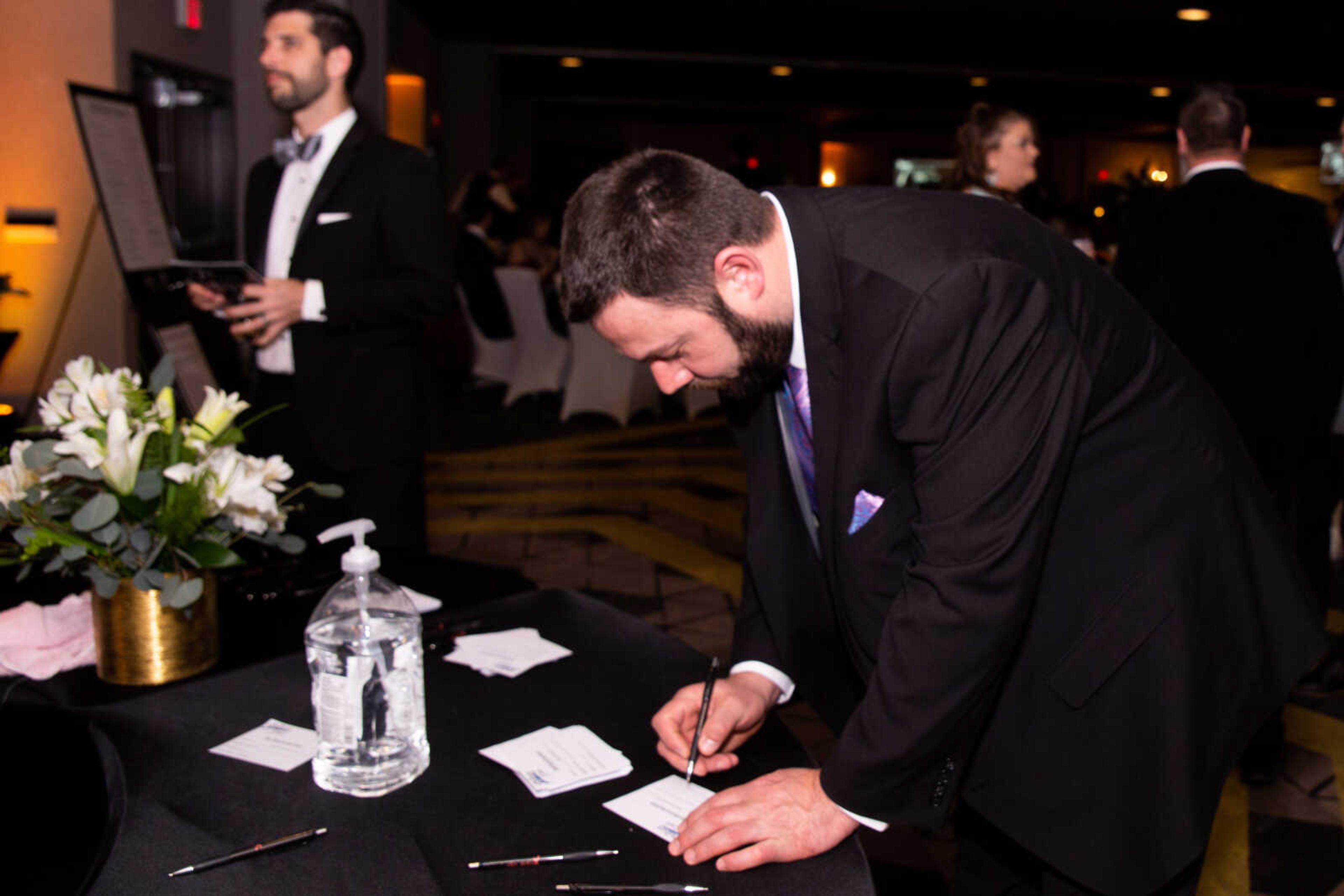 Justin Gentry places a bid on an auction item at the gala.