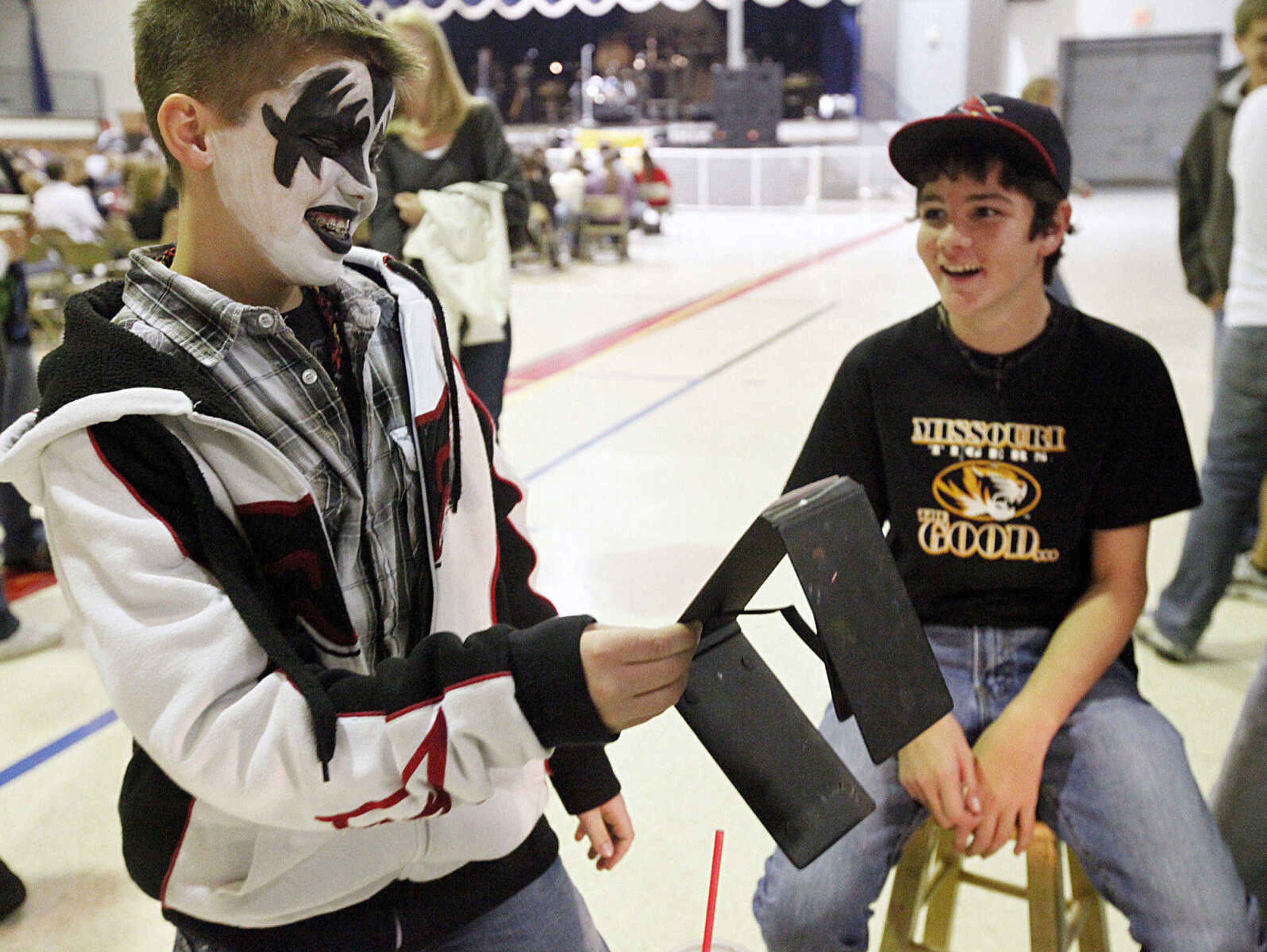 CHRIS MACKLER ~ photos@semissourian.com

Connor Klein, 12, admires his face paint as Skylar Pease, 13, looks on before the Kiss, AC/DC and Rod Stewart Tribute Concert held at the Arena Building on Saturday, Nov. 6, 2010, in Cape Girardeau.