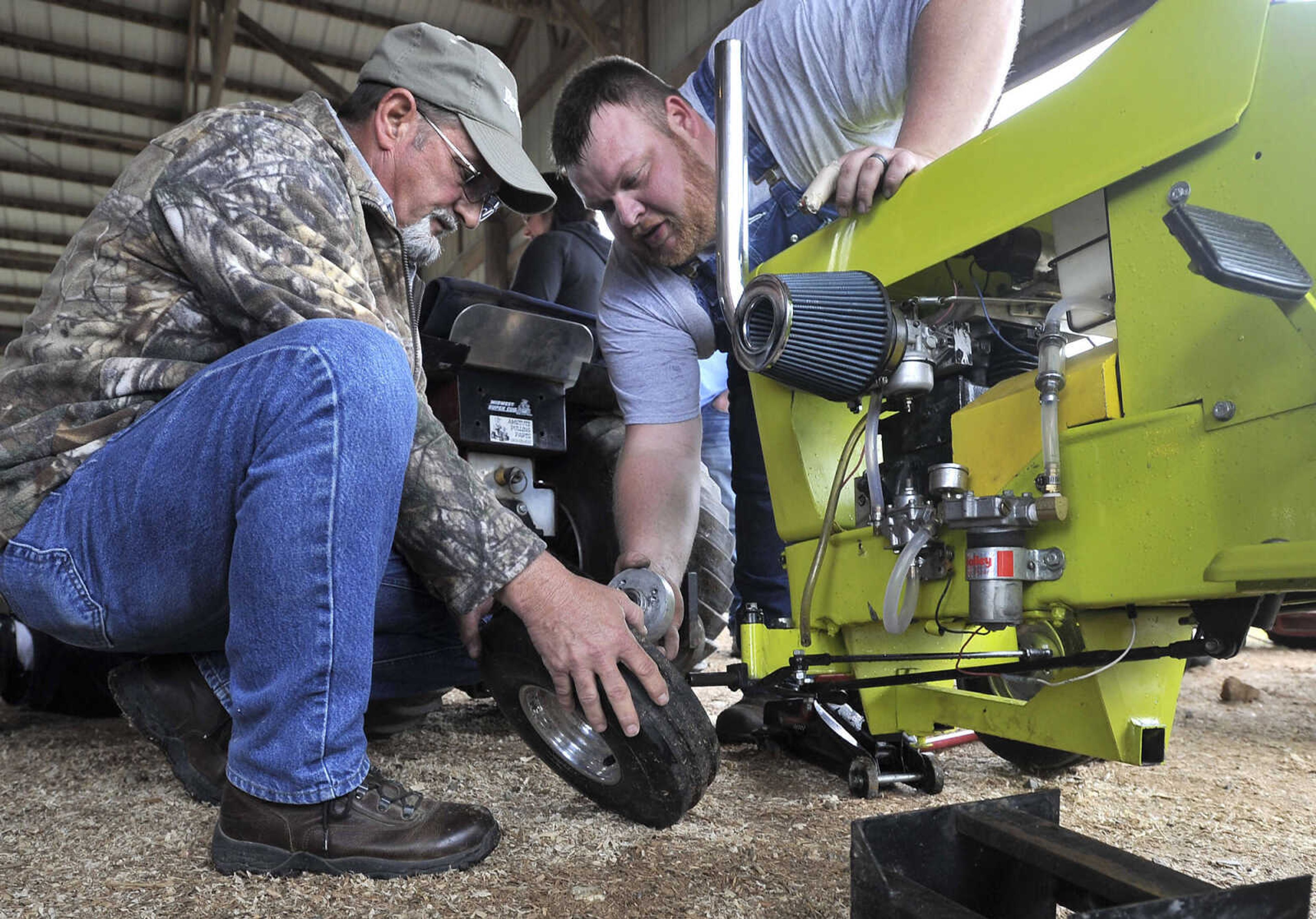 Jesse Fulton, left, of Patton Missouri assists Jeremy Rushing of Dudley, Missouri with an International Cub at the Cousin Carl Farm Show on Saturday, March 12, 2016 at Arena Park.