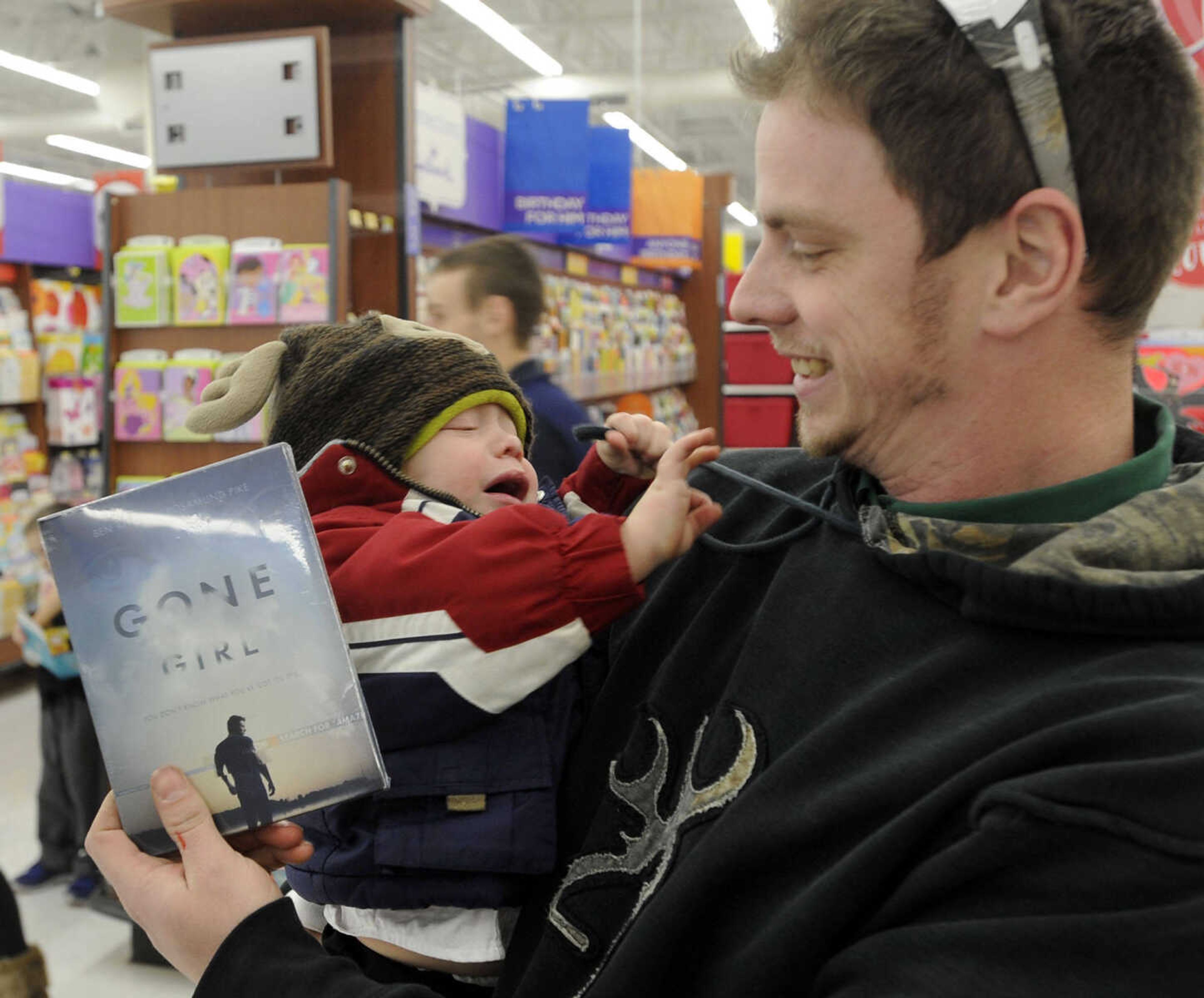 FRED LYNCH ~ flynch@semissourian.com
Bobby Younce and his son, Landon, pick up the first "Gone Girl" DVD made available at a midnight release Tuesday, Jan. 13, 2015 at Walmart in Cape Girardeau.