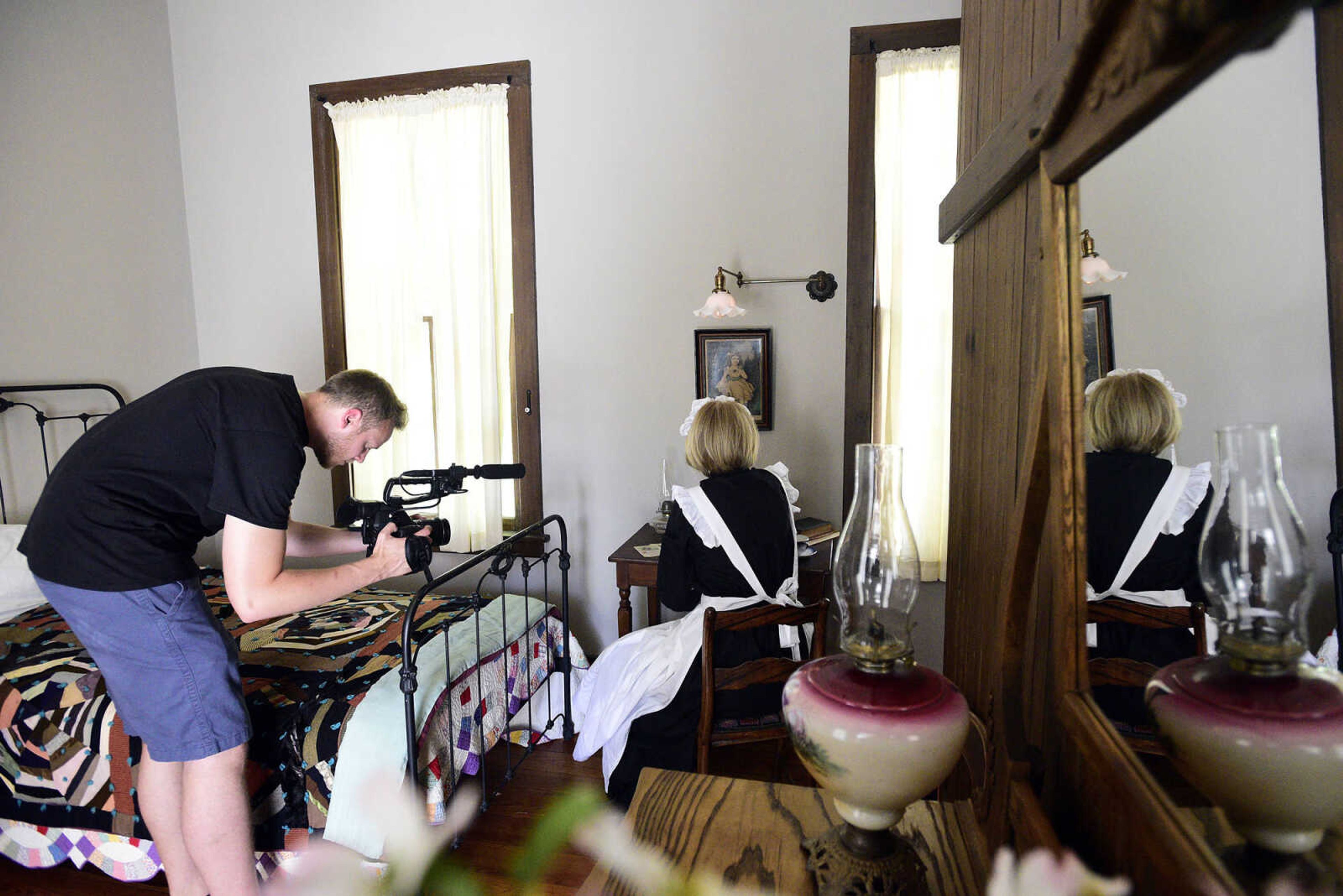 Eric Boedeker from KMOS-TV films Linda Ingram inside the servant's quarters at the Glenn House on Wednesday, Aug. 16, 2017, in Cape Girardeau. KMOS-TV, a PBS affiliate, was filming inside the historic home for its Missouri Life show.