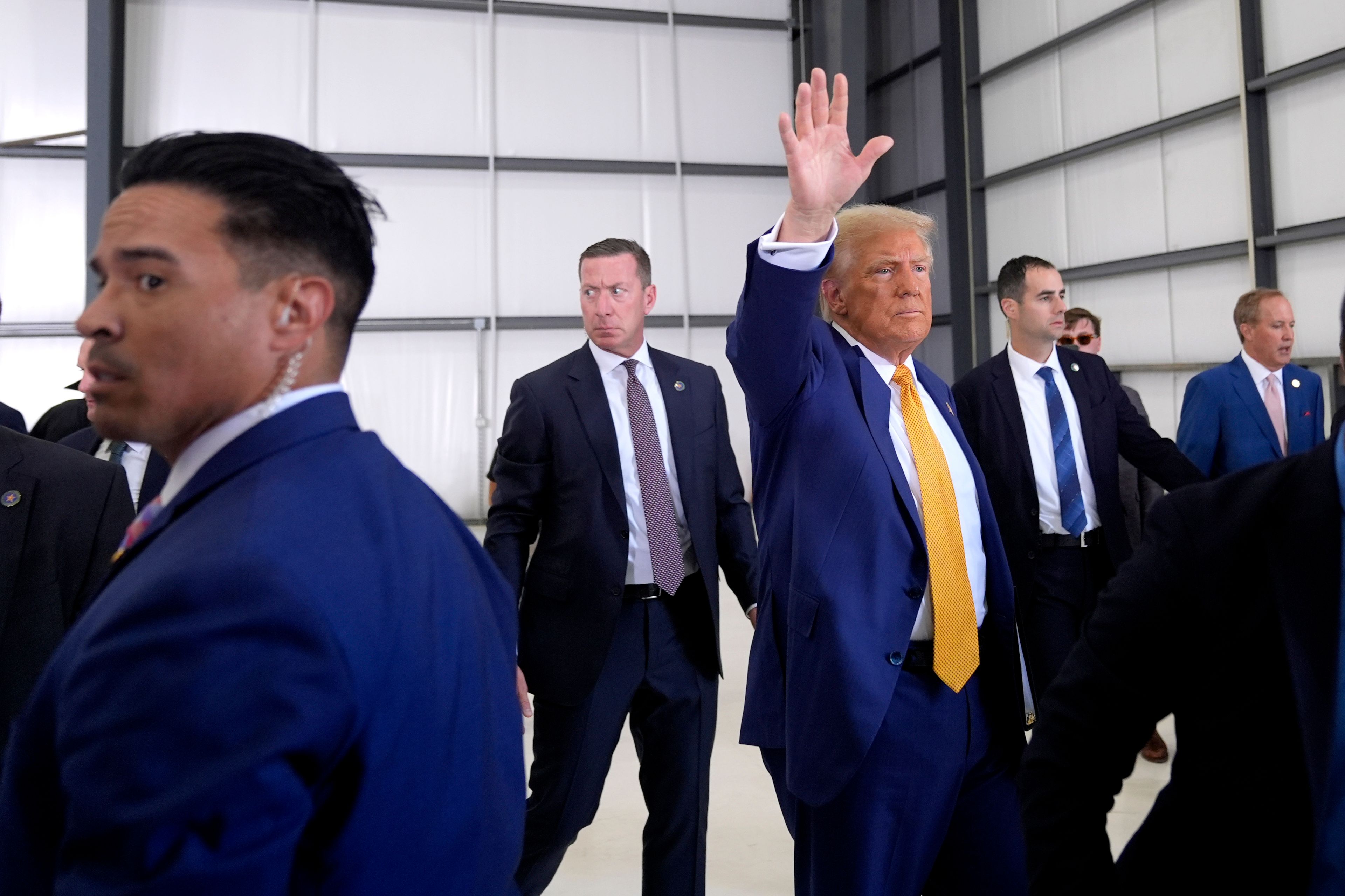 Republican presidential nominee former President Donald Trump waves as he departs a news conference at Austin-Bergstrom International Airport, Friday, Oct. 25, 2024, in Austin, Texas. (AP Photo/Alex Brandon)