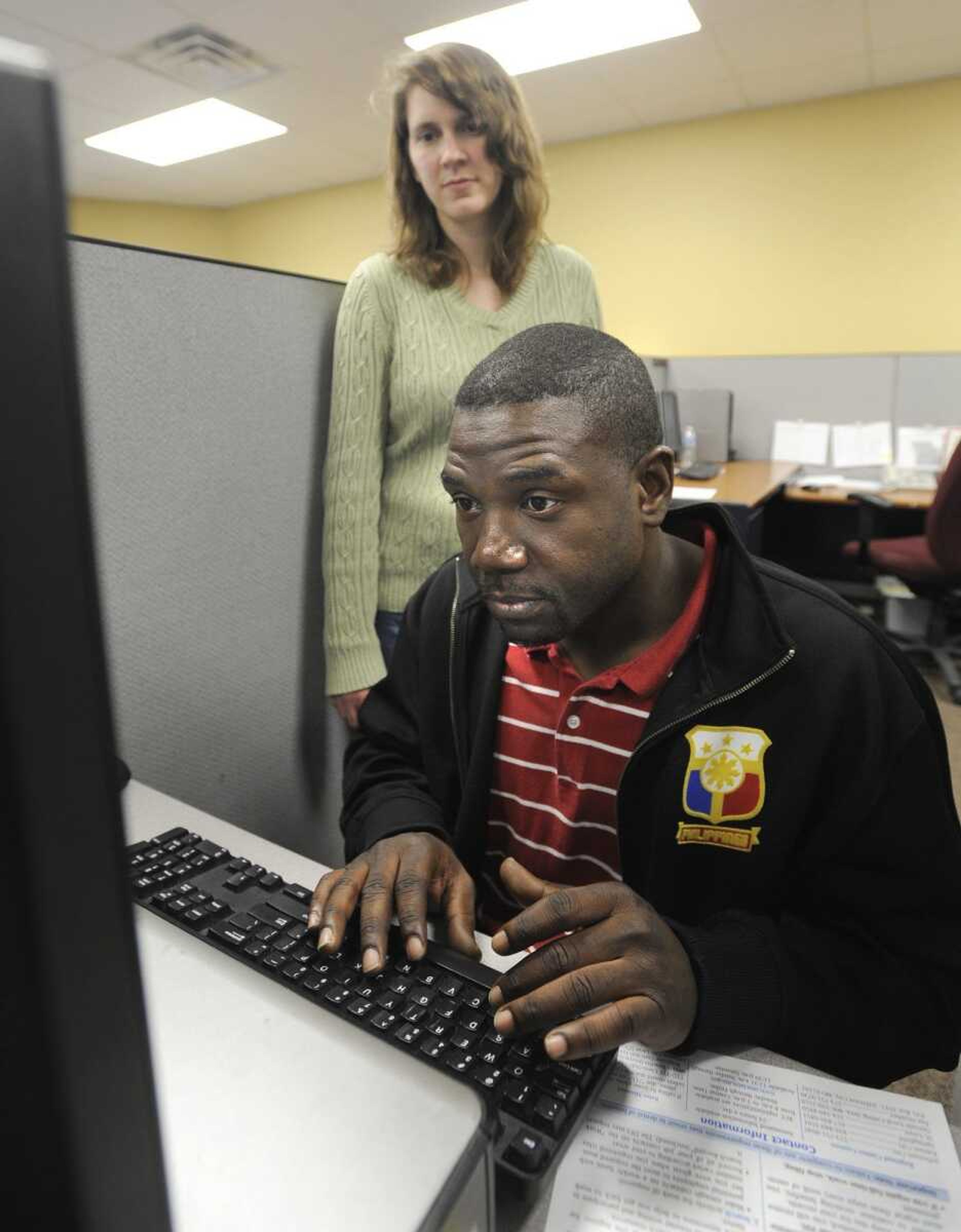 Workforce specialist Karla Pfefferkorn assists Ronald Schoffner in this file photo as he files a new unemployment form at the Missouri Career Center in Cape Girardeau. (Fred Lynch)