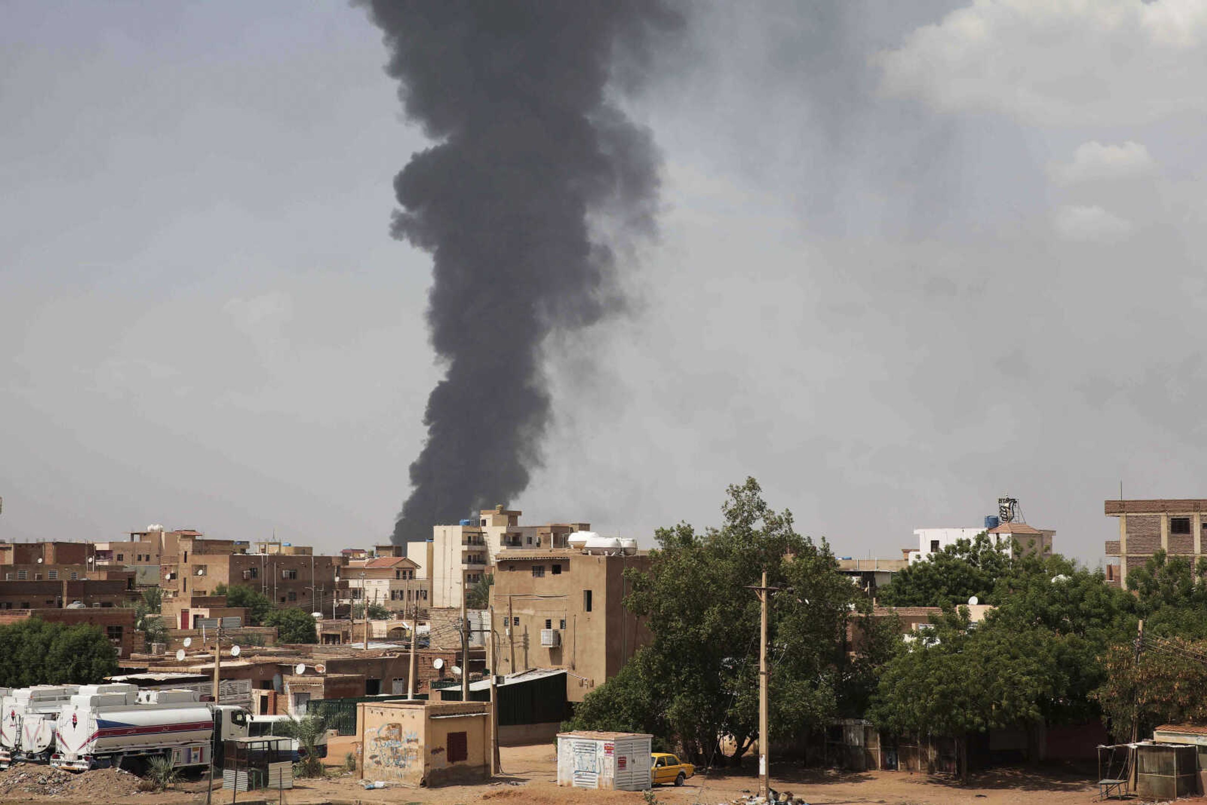 FILE - Smoke rises over Khartoum, Sudan, on June 8, 2023, as fighting between the Sudanese army and paramilitary Rapid Support Forces continues. A leading human rights group said on Thursday Aug. 3, 2023 Sudan's warring parties have committed "extensive war crimes" including mass killings of civilians, rape and sexual slavery of women in the ongoing conflict. (AP Photo, File)