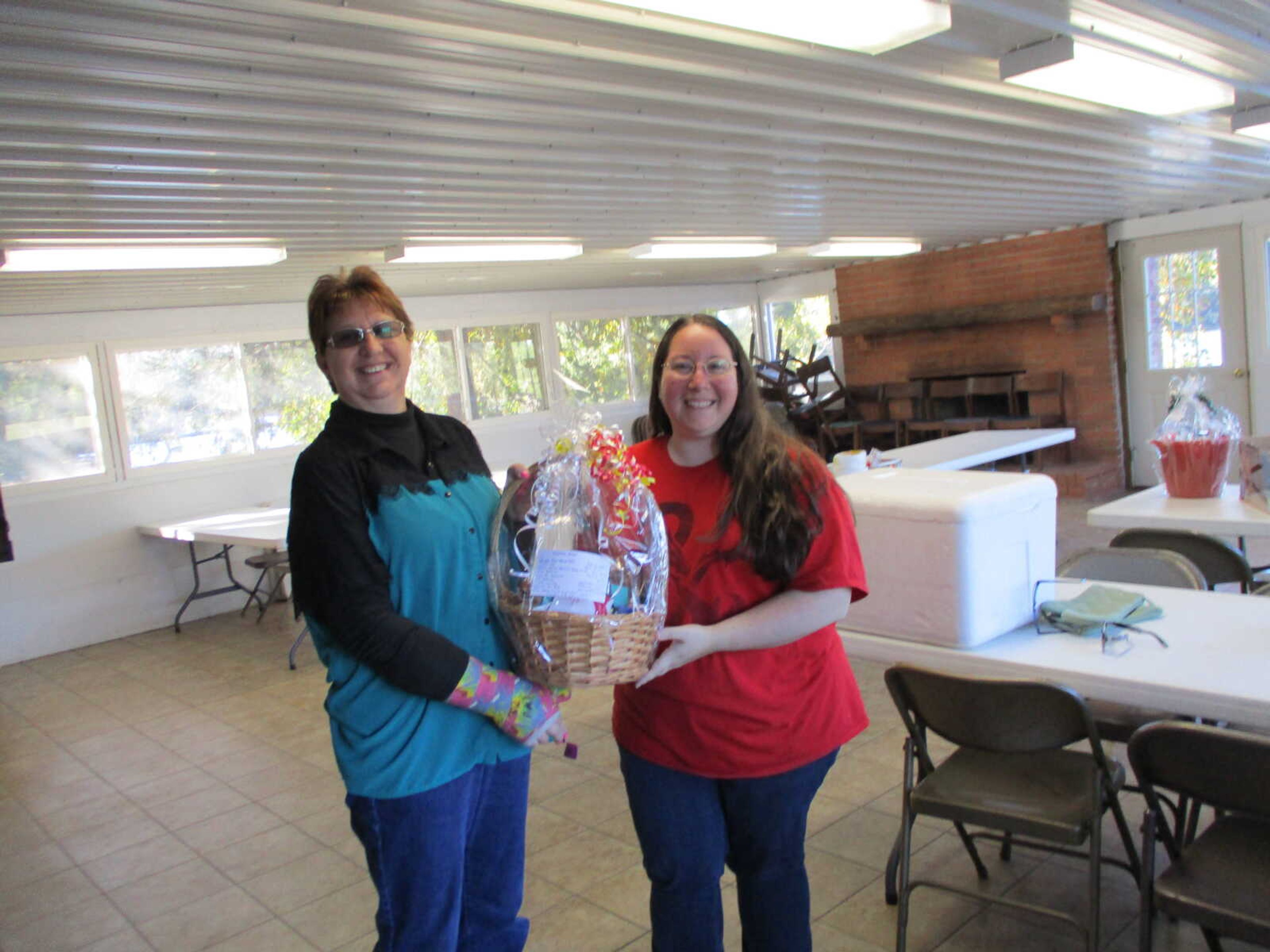 Chasity Bercey accepting her Women's basket by Marilyn Schott Facilitator of Brain Injury & Stroke Resource Group