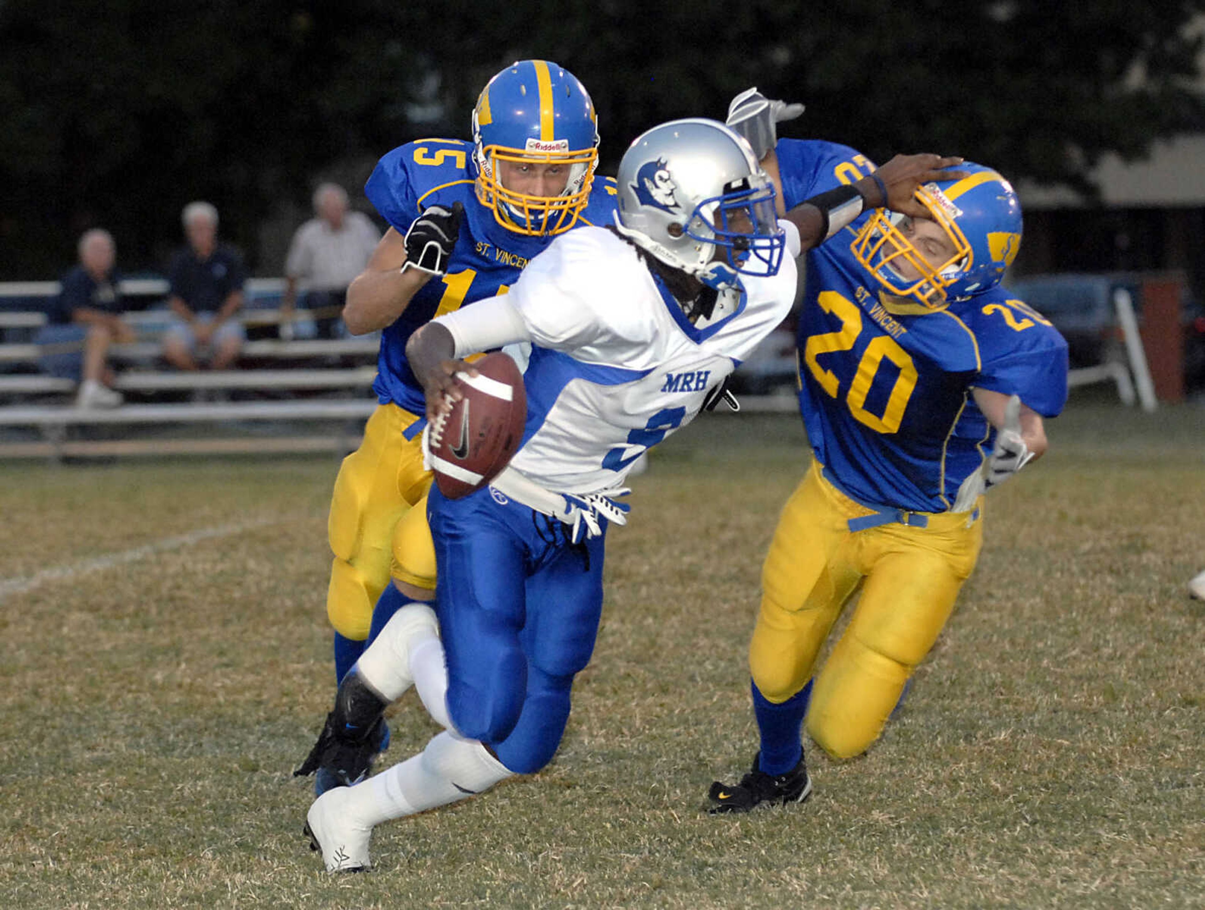 KIT DOYLE ~ kdoyle@semissourian.com
Maplewood quarterback Bryton Hobbs evades St. Vincent defenders Kyle Rollet, left, and Justin Eggers Friday evening, September 18, 2009, in Perryville.