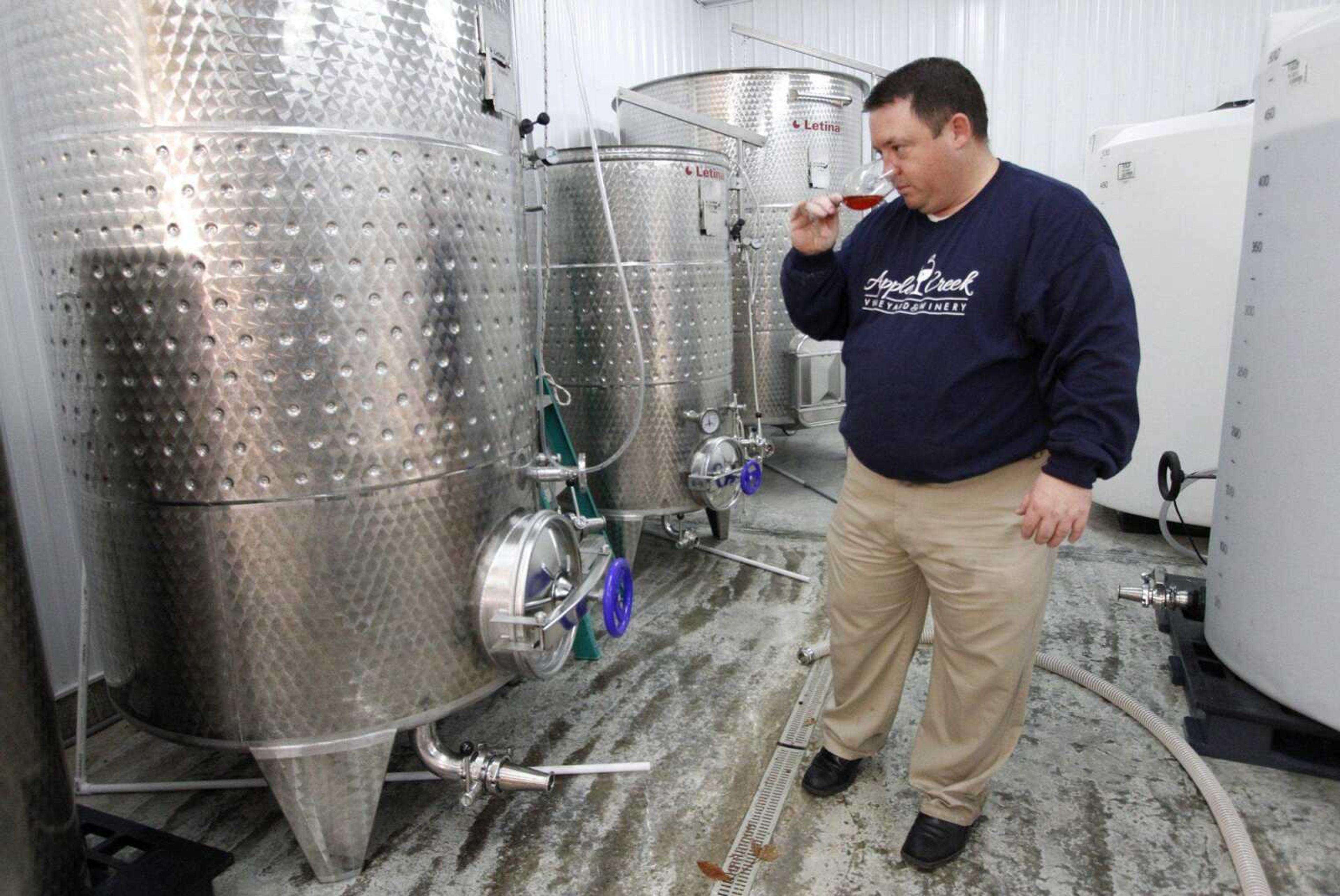 Matt Gamel samples a strawberry wine during the fermentation process Dec. 12 at Apple Creek Winery in Friedheim. (Chris Lee ~ St. Louis Post-Dispatch)