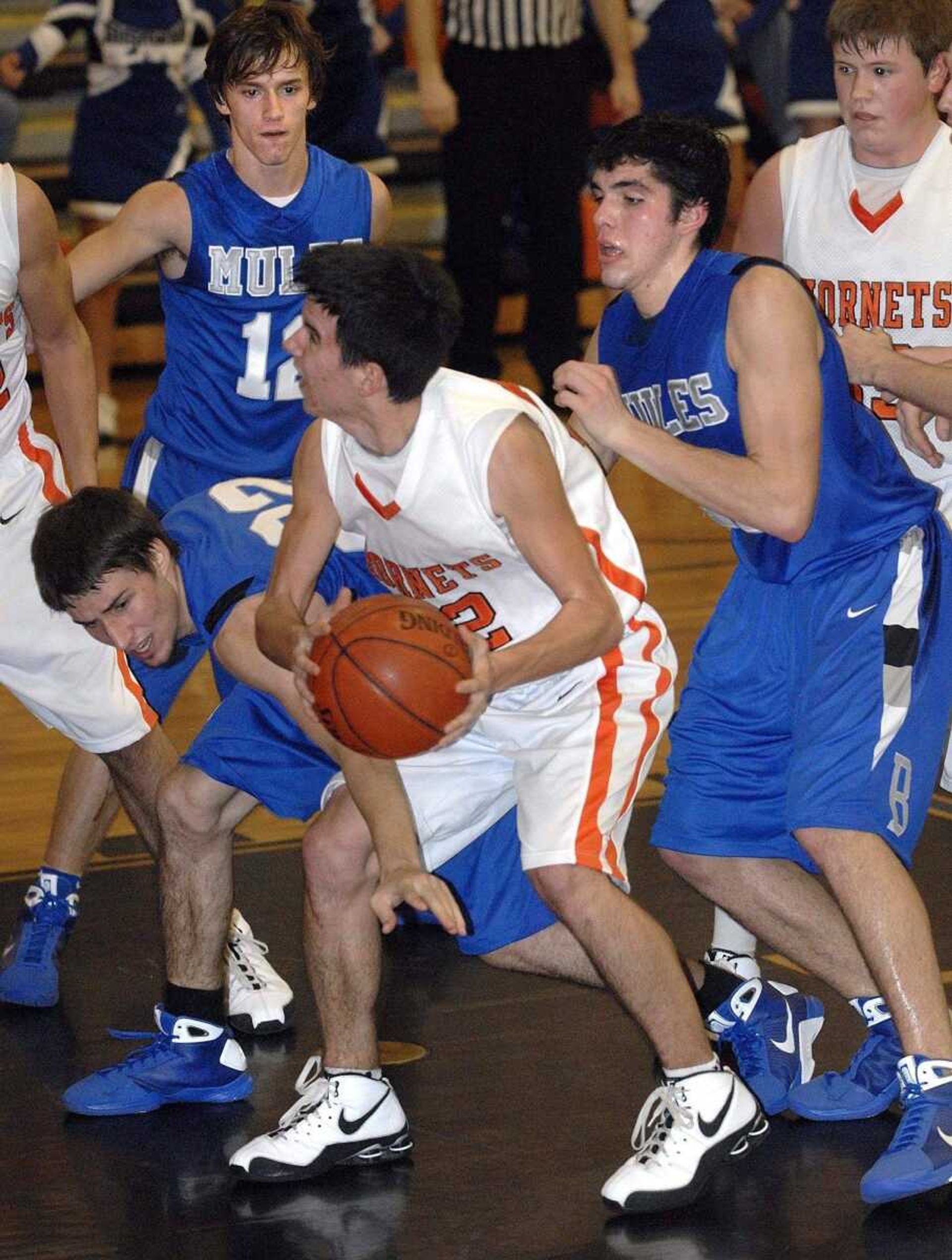 FRED LYNCH ~ flynch@semissourian.comAdvance's Blake Seabaugh keeps the ball away from Bernie's Jake Owens as Bernie's Jake Welch and Daniel Becking defend during the second quarter Friday at Advance.