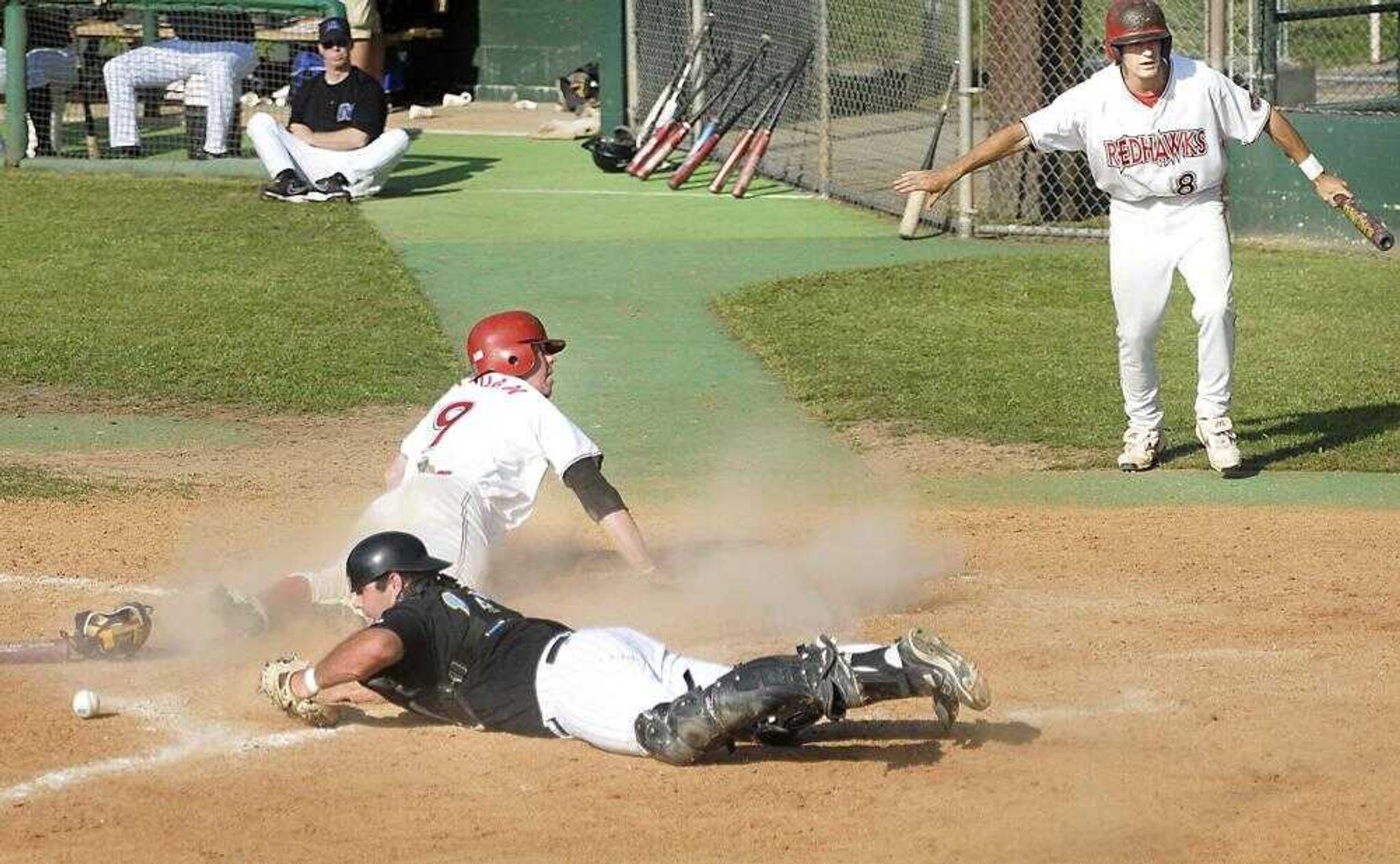 Southeast Missouri State senior Daryl Graham (9) looked for the call after scoring as Morehead State catcher Jarred Seasor lost the ball during the fourth inning of the second game of a doubleheader at Capaha Field on Saturday. Southeast's Nick Harris (8) gave his opinion on the outcome. (Kit Doyle)