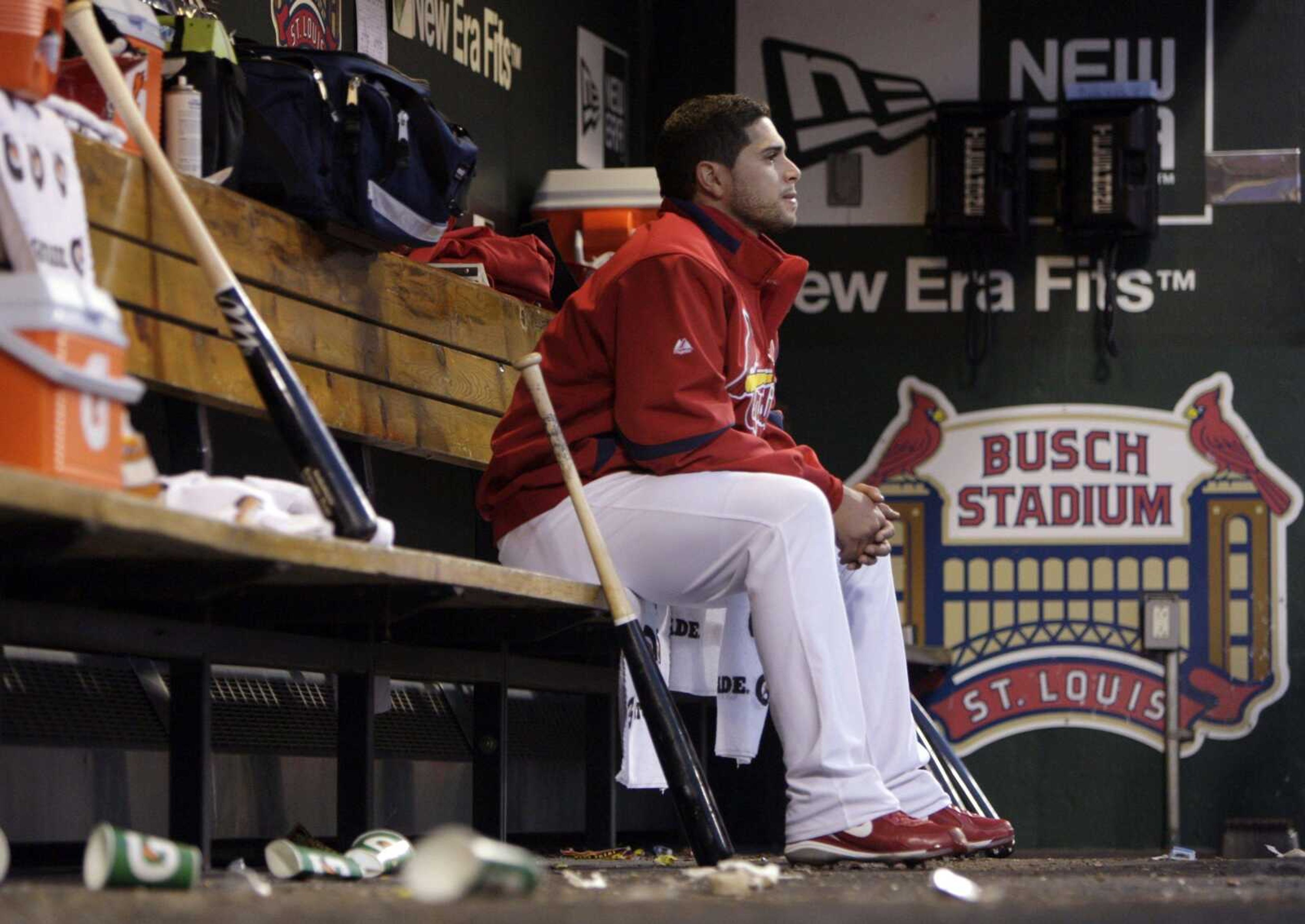 Cardinals starting pitcher Joel Pineiro sits alone in the dugout during the fifth inning after being pulled out of Game 3 of the National League division series in St. Louis. (JEFF ROBERSON ~ Associated Press)