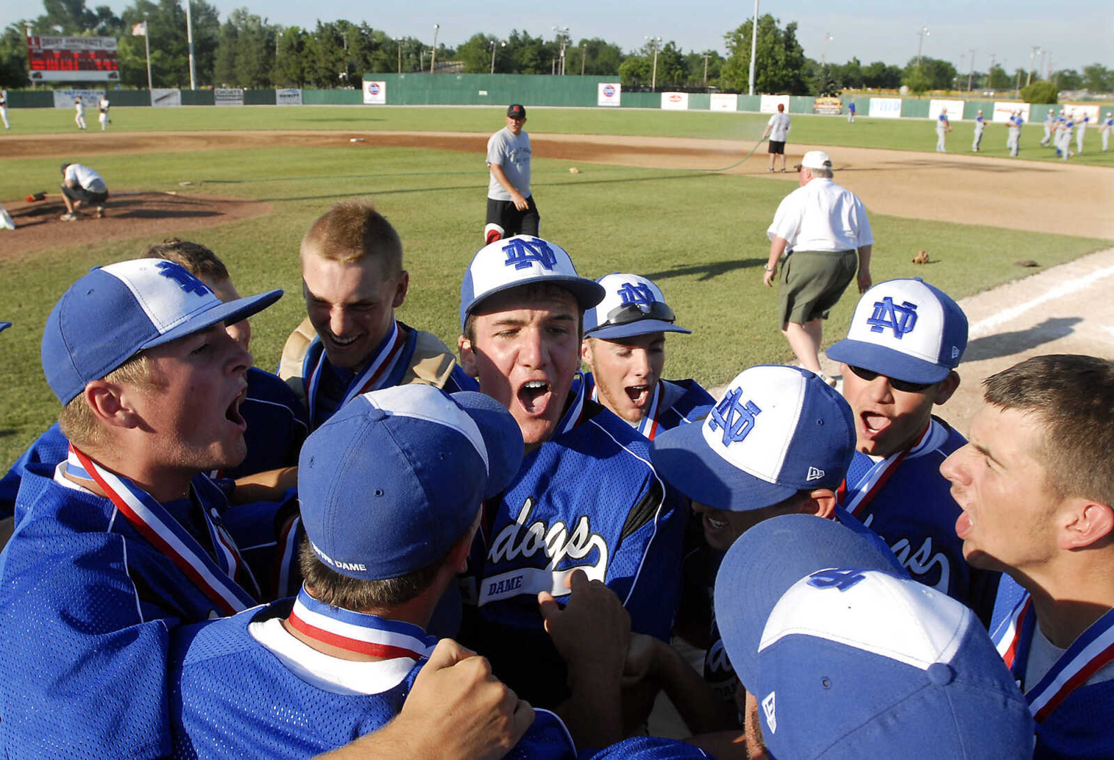 JUSTIN KELLEY photo
Notre Dame players celebrate after receiving their championship trophy and medals following the Class 3 championship game Saturday, June, 6 2009, against Carl Junction at Meador Park in Springfield.