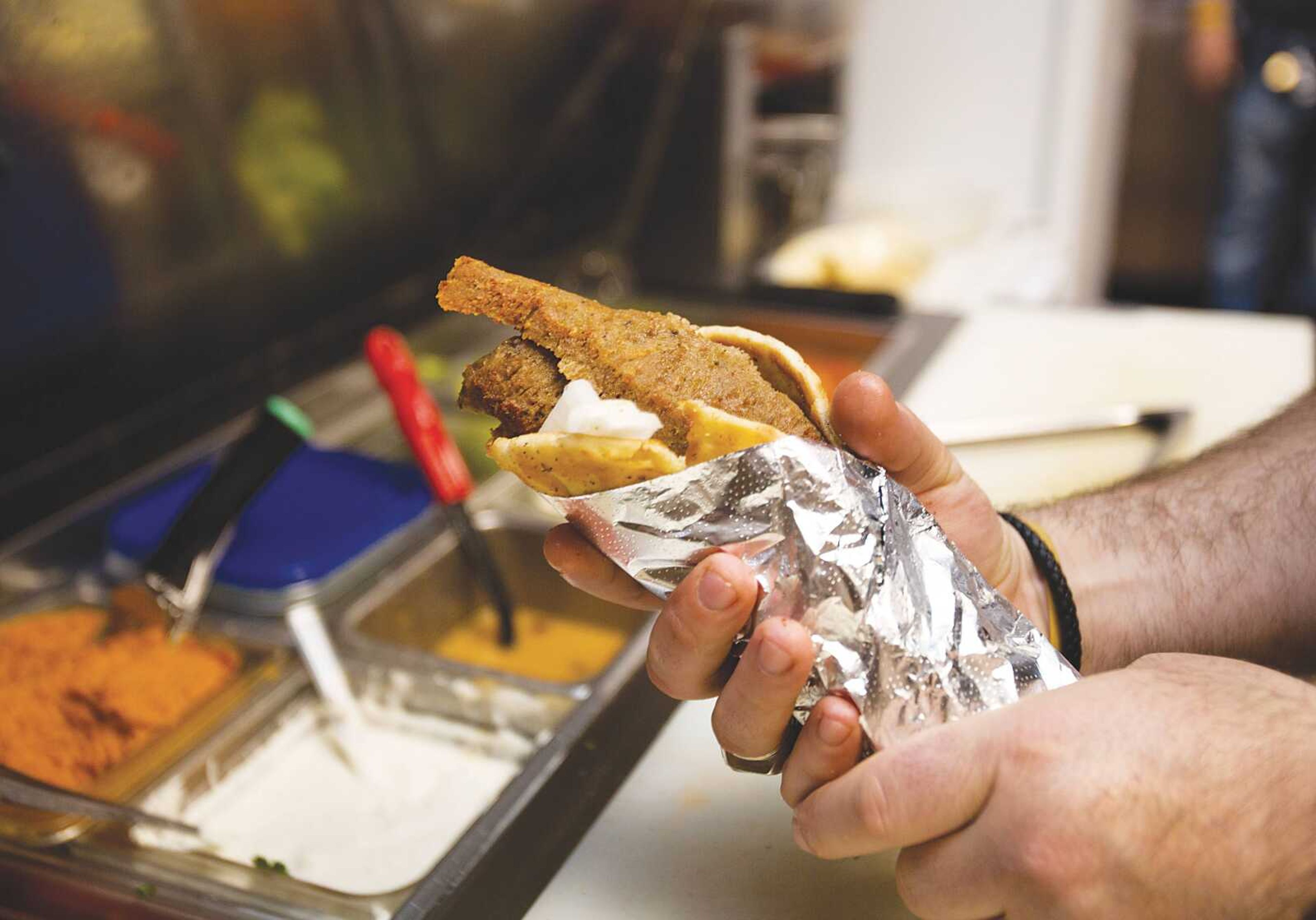 Georgios Kastanias wraps a gyro in foil before delivering it to a customer at Zoi's Gyros Corner in Cape.