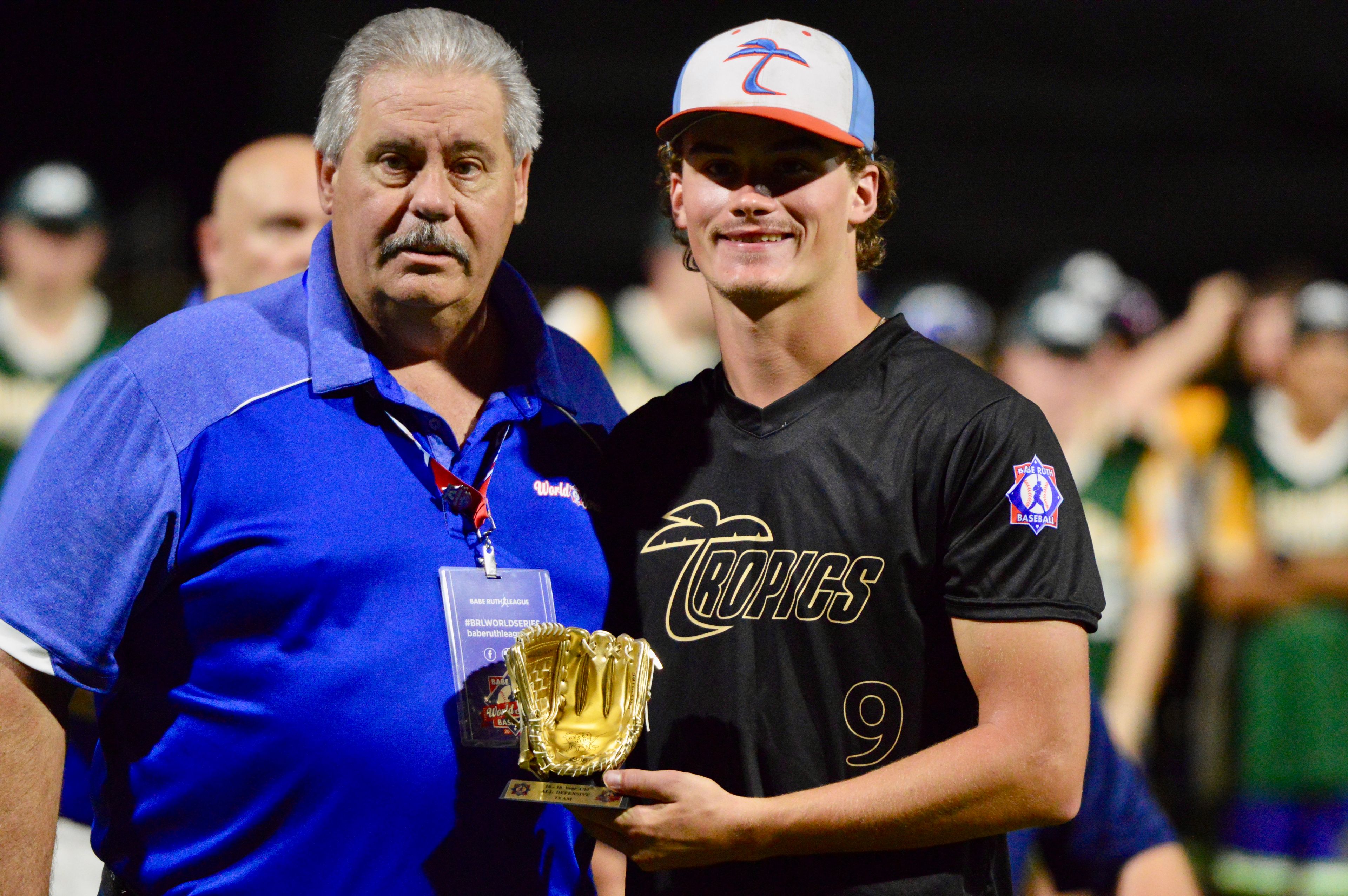 Southeast Tropics’ Mason Adams is handed an All-Star trophy at the Babe Ruth World Series on Thursday, Aug. 15, at Capaha Field in Cape Girardeau, Mo. 