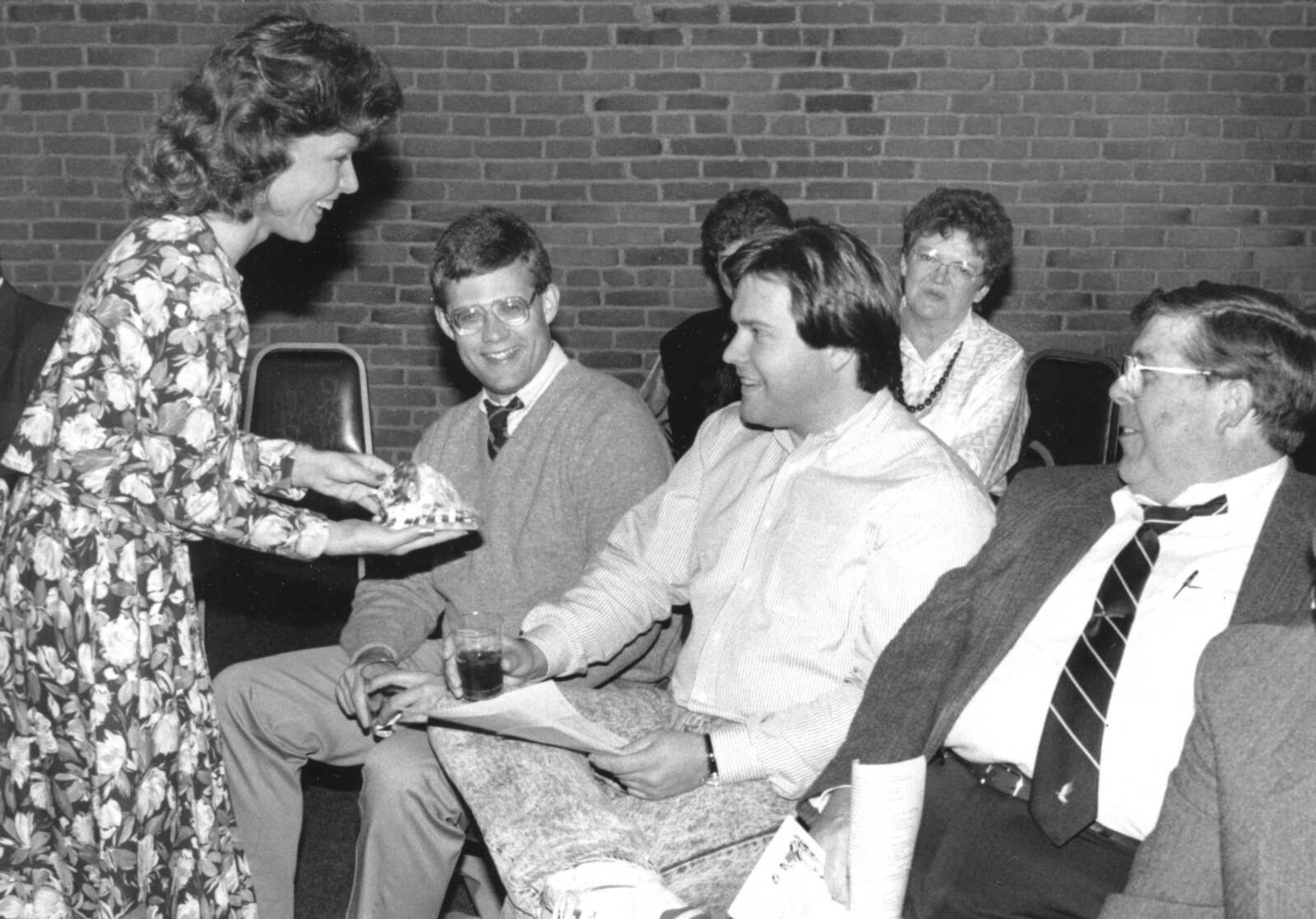 Published Dec. 8, 1989.
Melody Hutson, left, shows a hand-carved cameo shell to Tom Stine, David Barklage and J. Ronald Fischer during the third annual holiday auction Thursday at the Port Cape Girardeau restaurant. The auction of items donated by city merchants raised just over $8,000 for the downtown Holiday Decoration Fund. (Fred Lynch ~ Southeast Missourian archive)