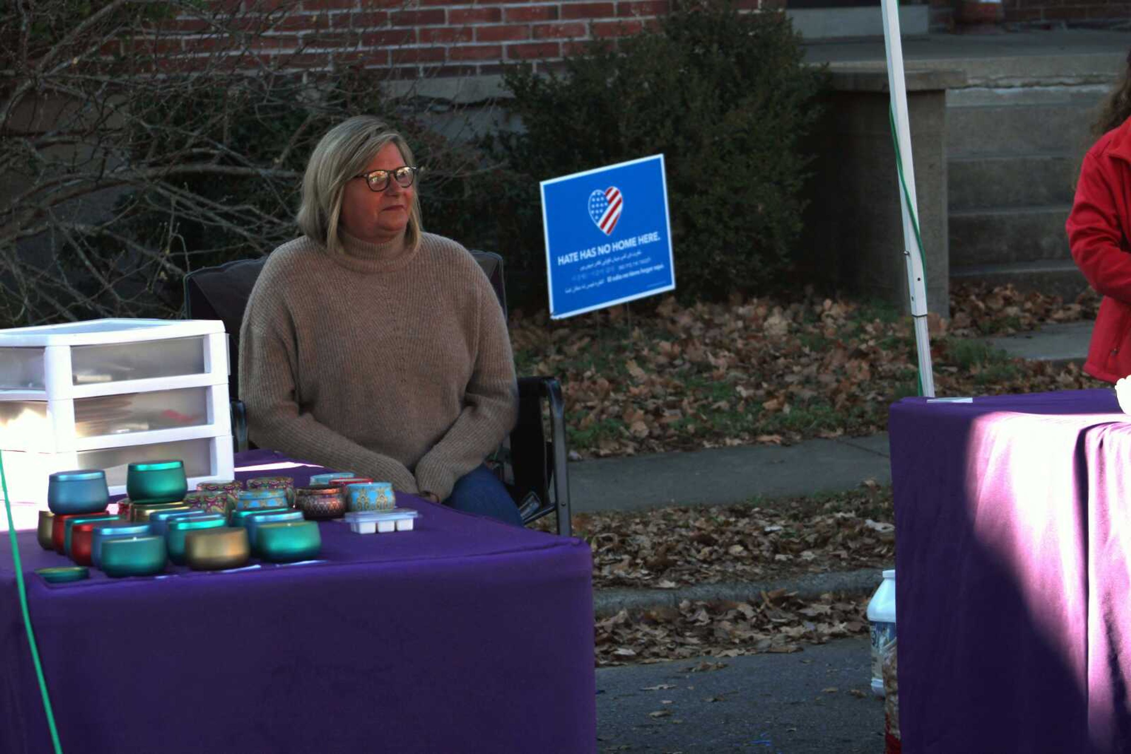 A vendor sits at her booth and waits for customers during the third annual Old Town Cape, Inc. Holiday Bazaar Saturday, Dec. 5, 2021, on Frederick Street in downtown Cape Girardeau.