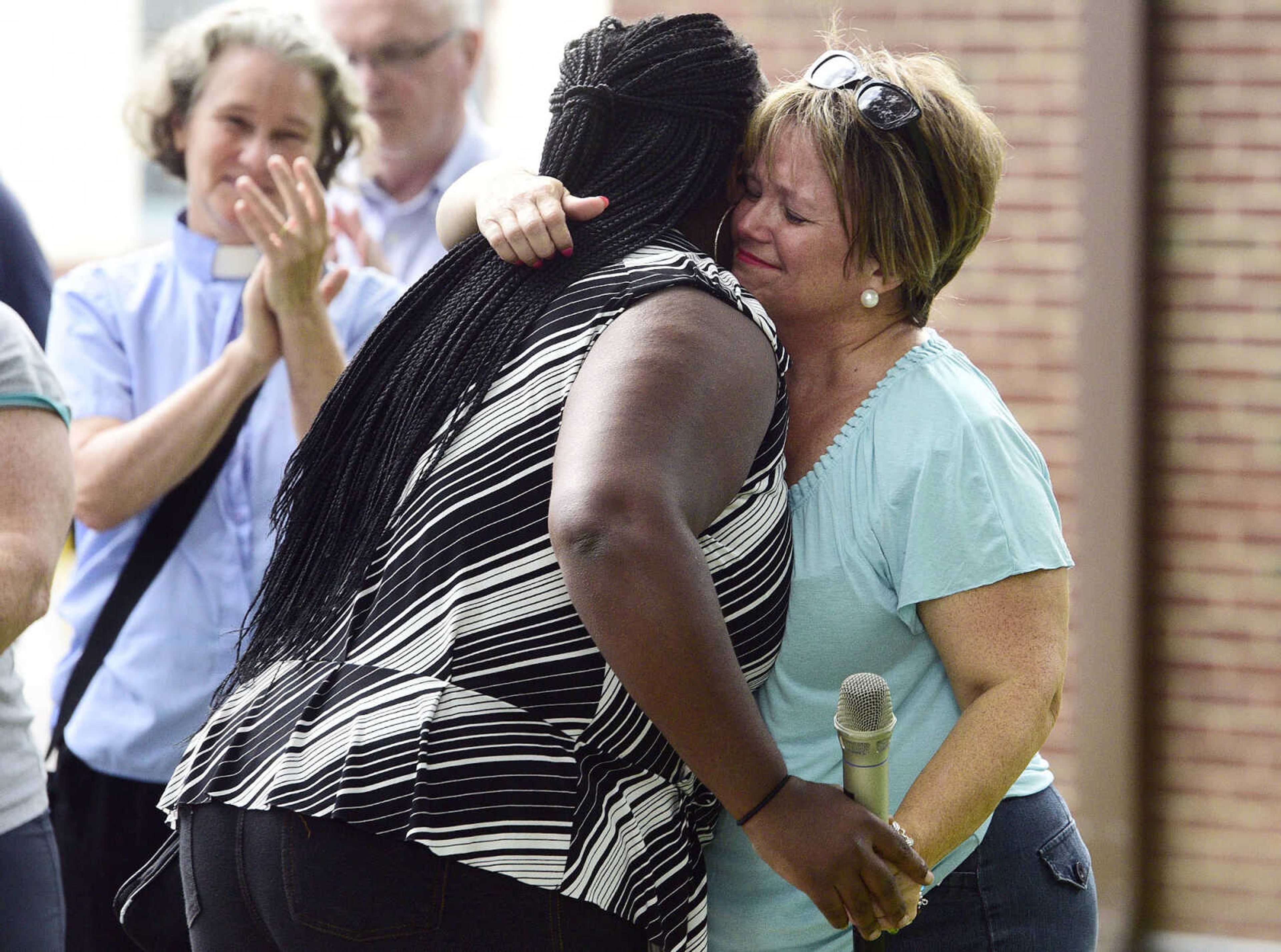 Rev. Renita Green, right, pastor of St. James AME, embraces Ramona Bailey after Bailey sang "It is Well" during a Love, Not Hate rally organized by Green on Sunday evening, Aug. 13, 2017,&nbsp; at Ivers Square in Cape Girardeau. Green organized the rally in response to the weekend events in Charlottesville, Virginia.