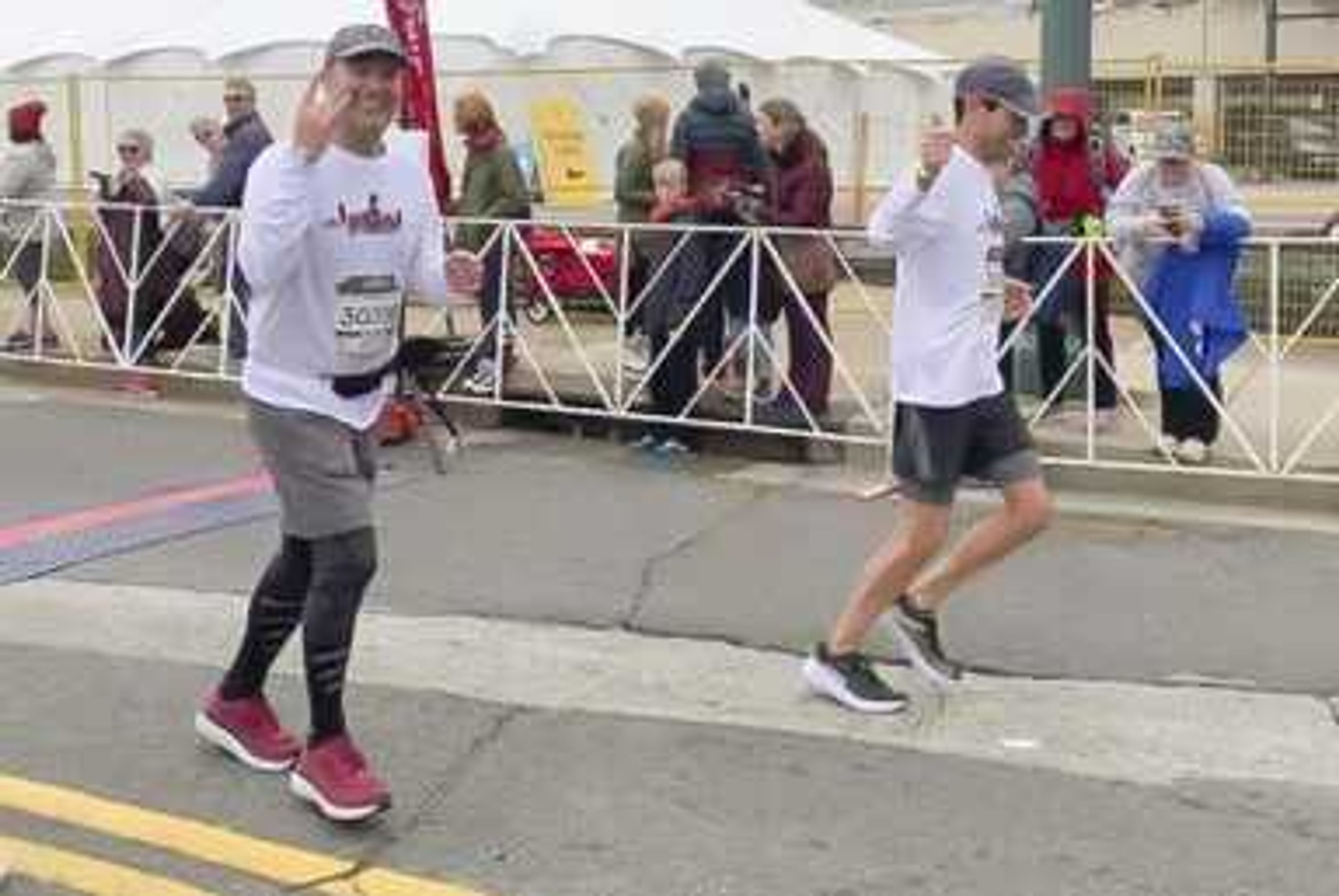 Scott Kruse, left, runs alongside his lifelong friend David Robinson during the St. Jude Memphis Marathon on Saturday in Memphis, Tennessee.