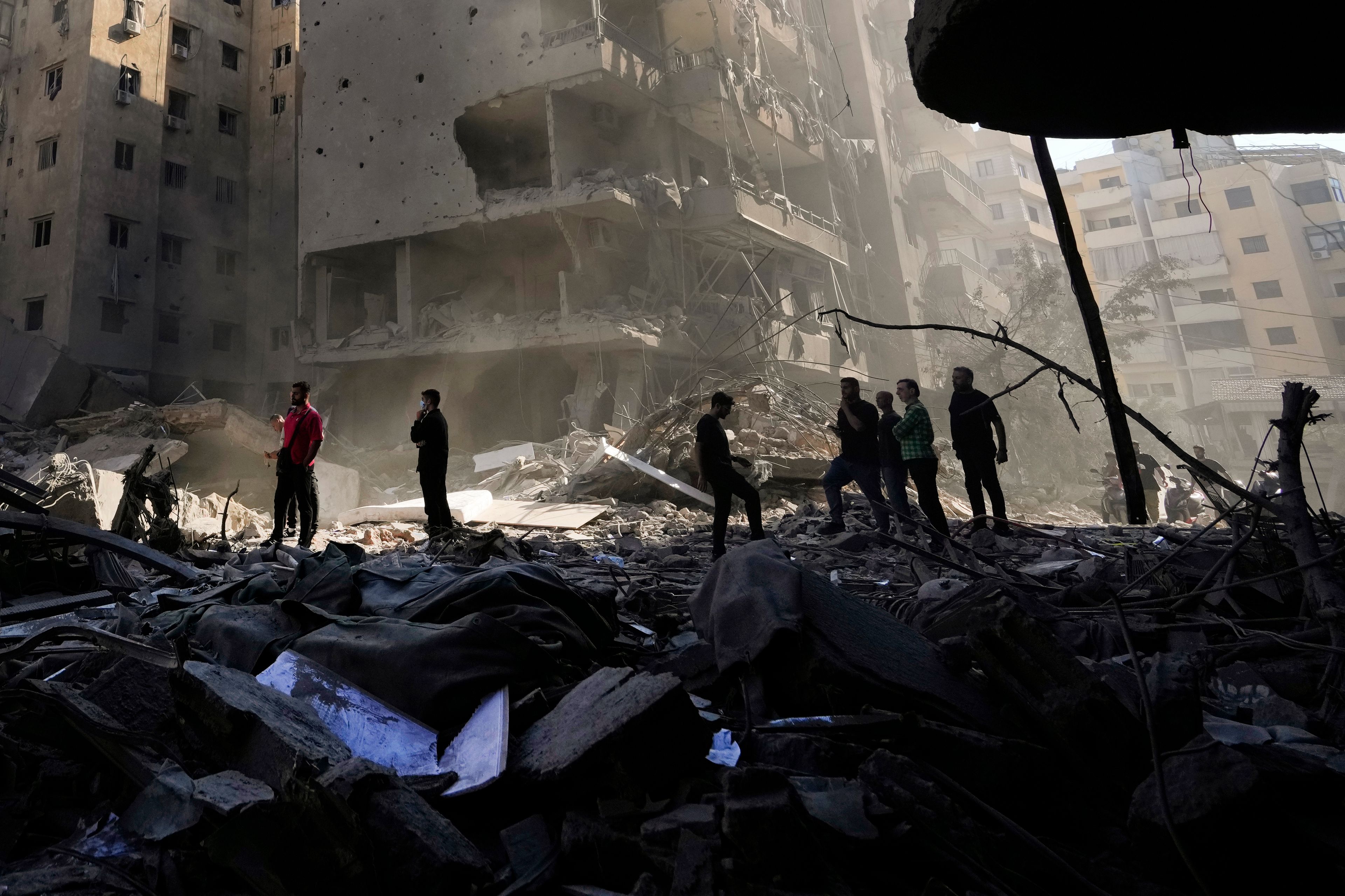 People check the site of the assassination of Hezbollah leader Hassan Nasrallah in Beirut's southern suburbs, Sunday, Sept. 29, 2024. (AP Photo/Hassan Ammar)