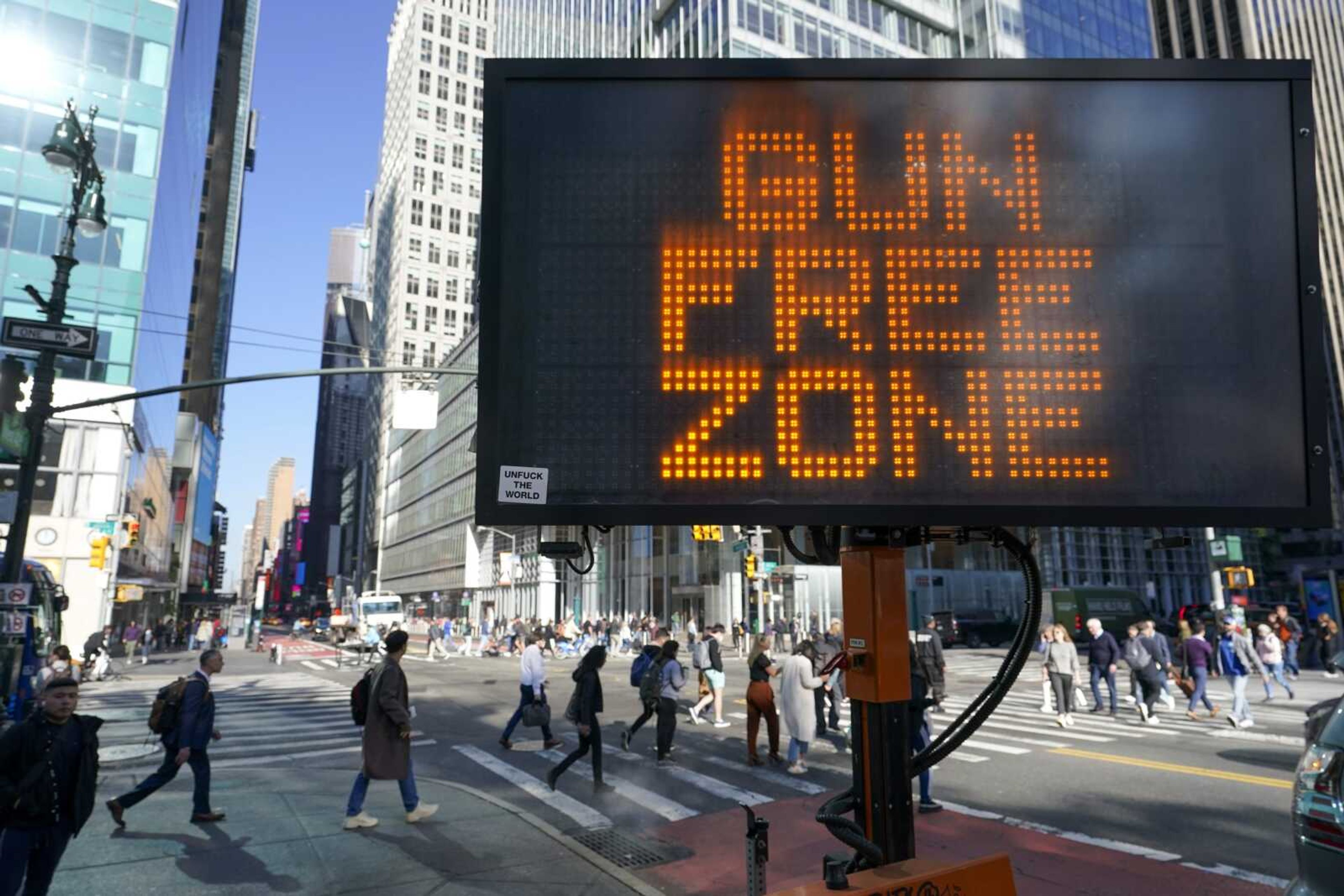 A traffic sign on the corner of 42nd Street and 6th Avenue announces Times Square as a gun free zone Oct. 11 in New York. The Supreme Court is allowing New York to continue to enforce a sweeping new gun law banning guns from "sensitive places" for now while a court challenge plays out. The justices on Wednesday turned away a plea by the law's challengers.