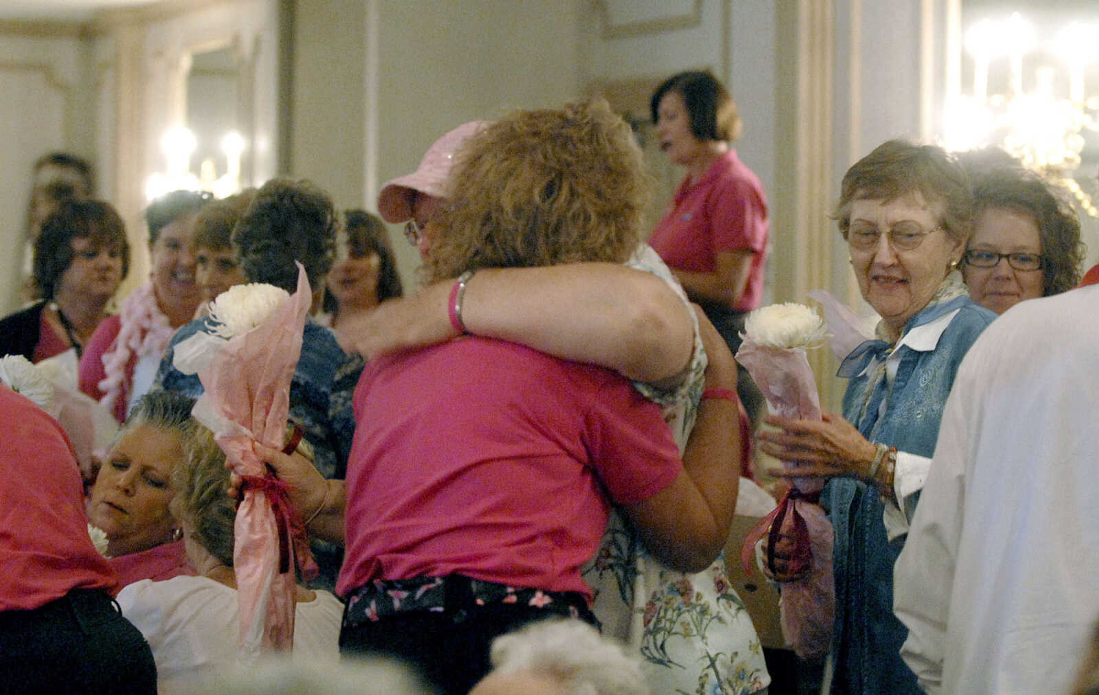 LAURA SIMON ~ lsimon@semissourian.com
Breast cancer survivors receive flowers during the survivor recognition during the 8th annual American Cancer Society Pink Ribbon Luncheon Wednesday, October 12, 2011 at Drury Lodge in Cape Girardeau. The luncheon featured a silent auction, live purse auction, speakers Lisa howe, Julie Metzger, Priscilla Mabuse and Lori Faire. All proceeds of the luncheon benefit cancer patients in southeast Missouri through the American Cancer Society's Cape Area Patient Service Fund.