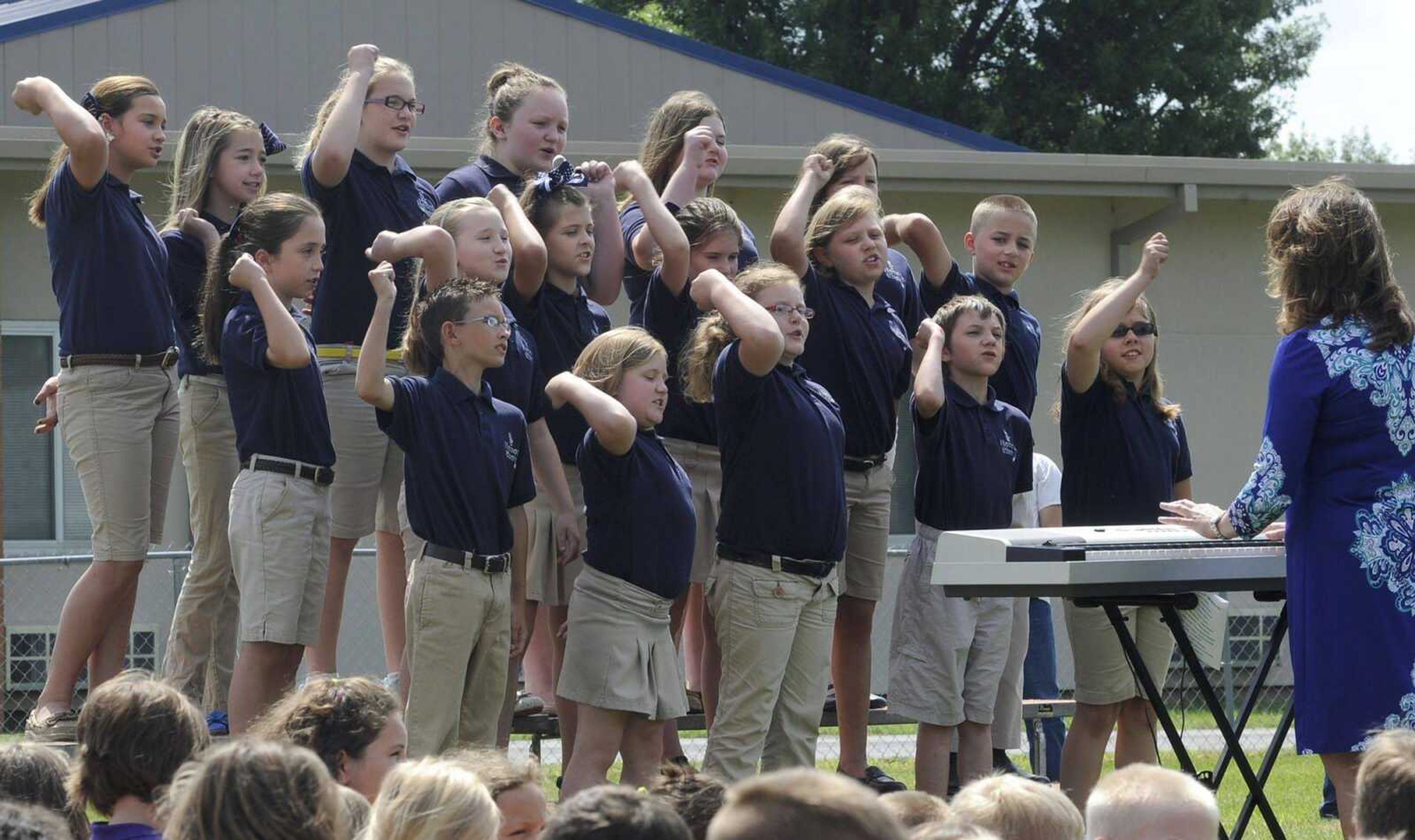 The Scott City Elementary Honor Choir, directed by Heather Sneed, sings a cheer song Monday at the groundbreaking ceremony for the Visual and Performing Arts Center at Scott City School. (Fred Lynch)