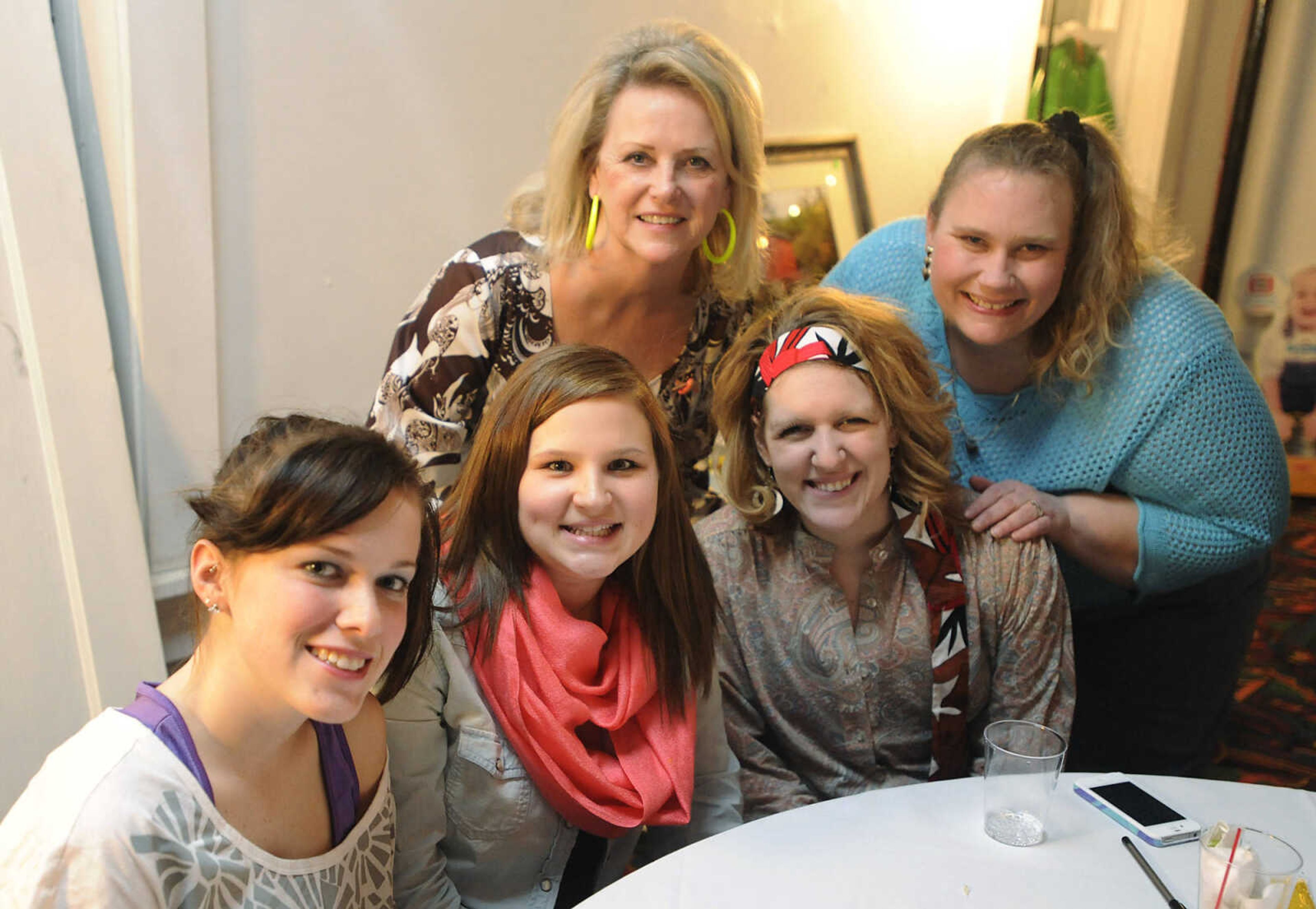 Staff members Ashley Minesleft, front left, Brittany Bequette, Mallory Wipfler, Pansy Glenn, back left, and Sarah Powell at Discovery Playhouse's '70s, '80s and '90s Trivia Night Friday, Feb. 22.