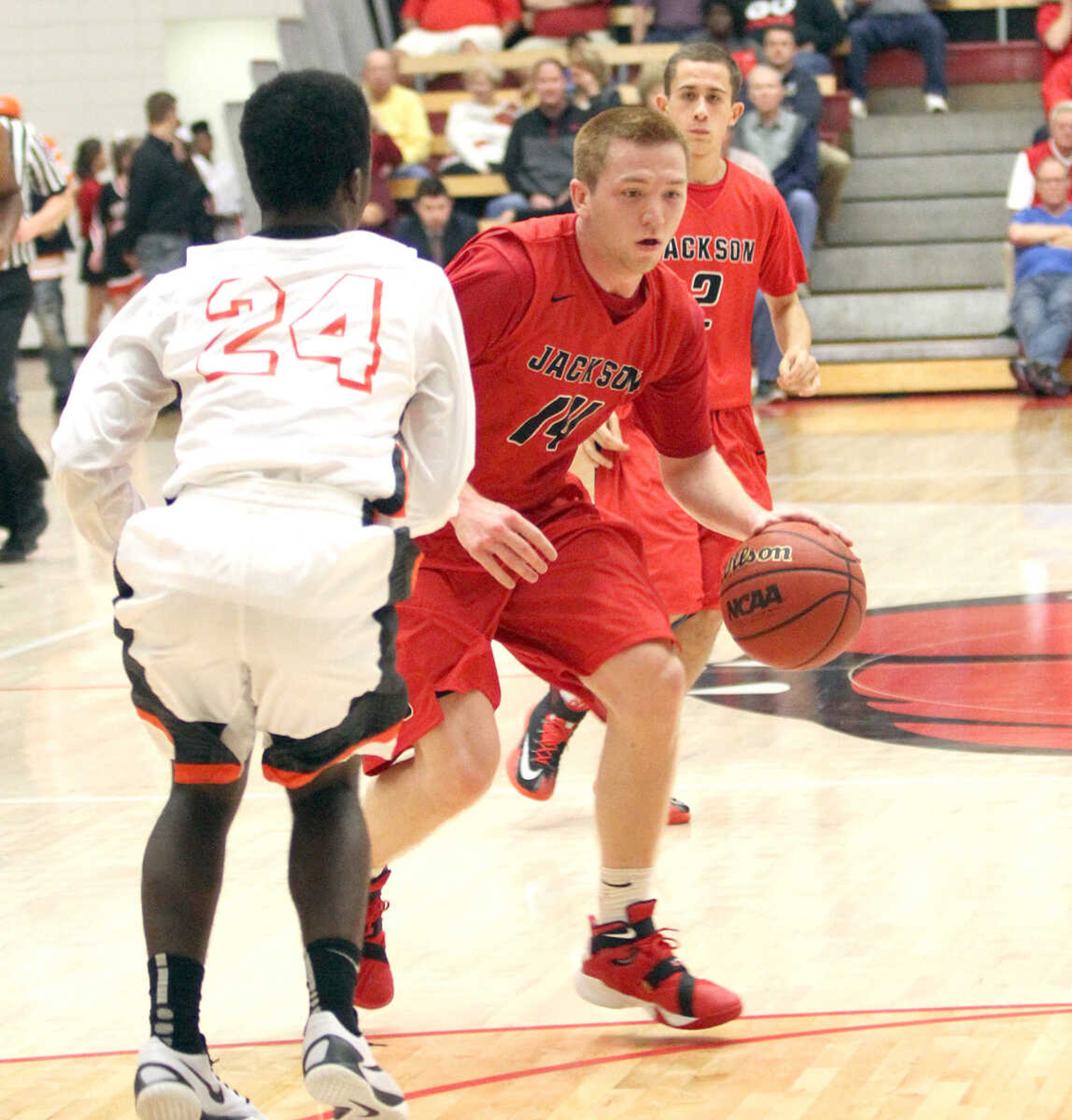 Jackson's Jacob Smith drives to the basket while being guarded by Cape Central's Kway'Chon Chisom in the consolation finals of the SEMO Conference Tournament on Friday night at the Sikeston Field House. (David Jenkins/Standard Democrat)