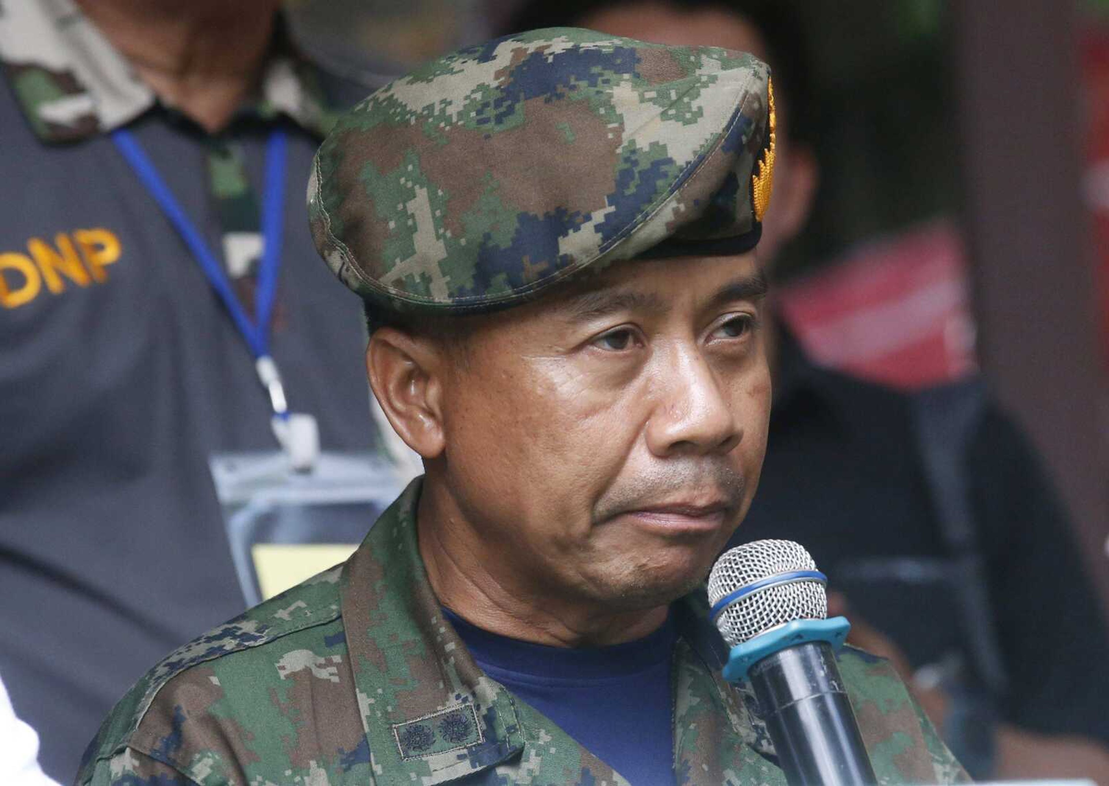 Thai SEALs commander Arpakorn Yookongkaew talks to reporters during a press conference Friday in Mae Sai, northern Thailand. A Thai navy diver working as part of the effort to rescue 12 boys and their soccer coach trapped in a flooded cave died Friday from lack of oxygen, underscoring risks of extracting the team.