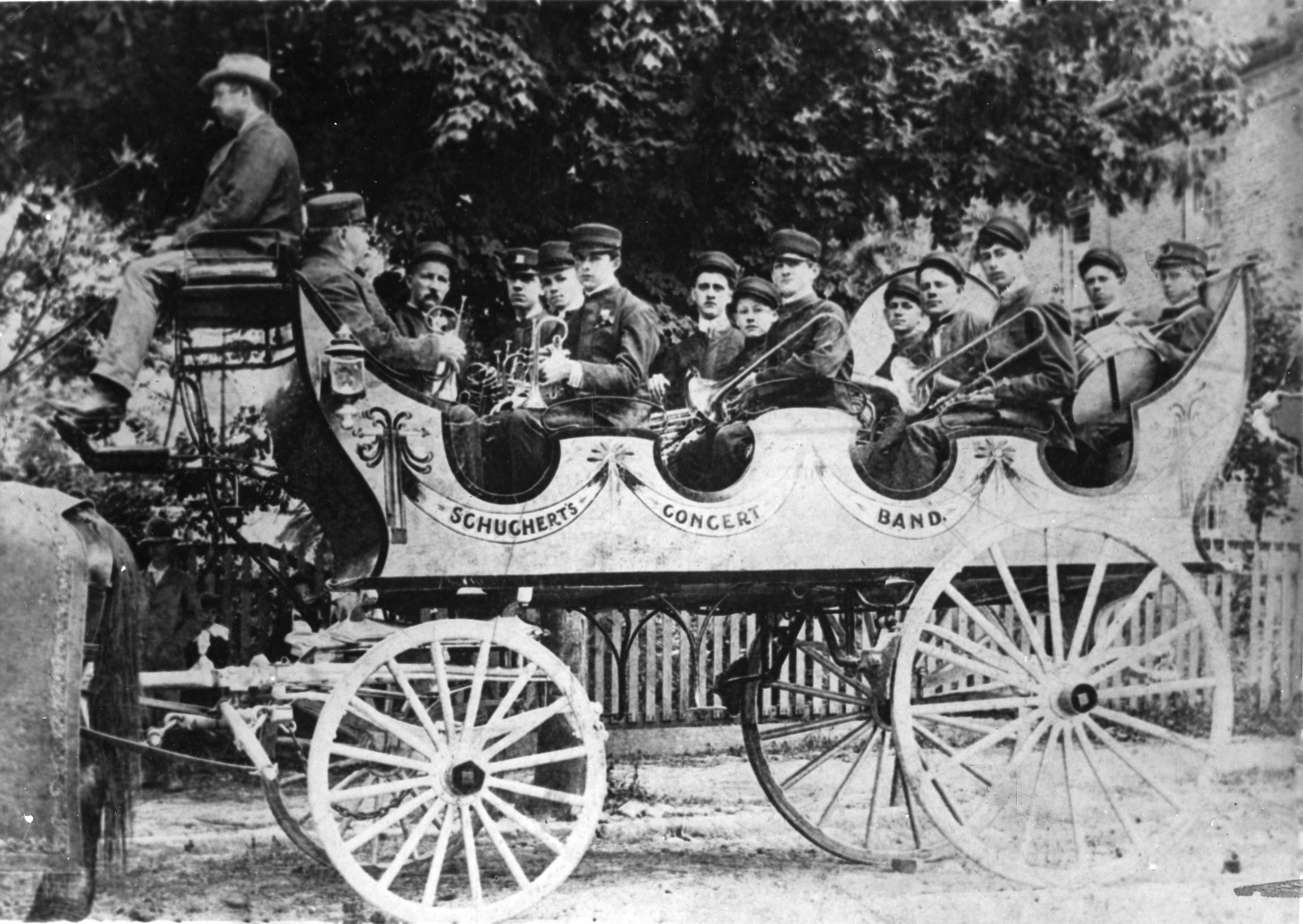 The Schuchert Concert Band rides in its band wagon, circa 1890.