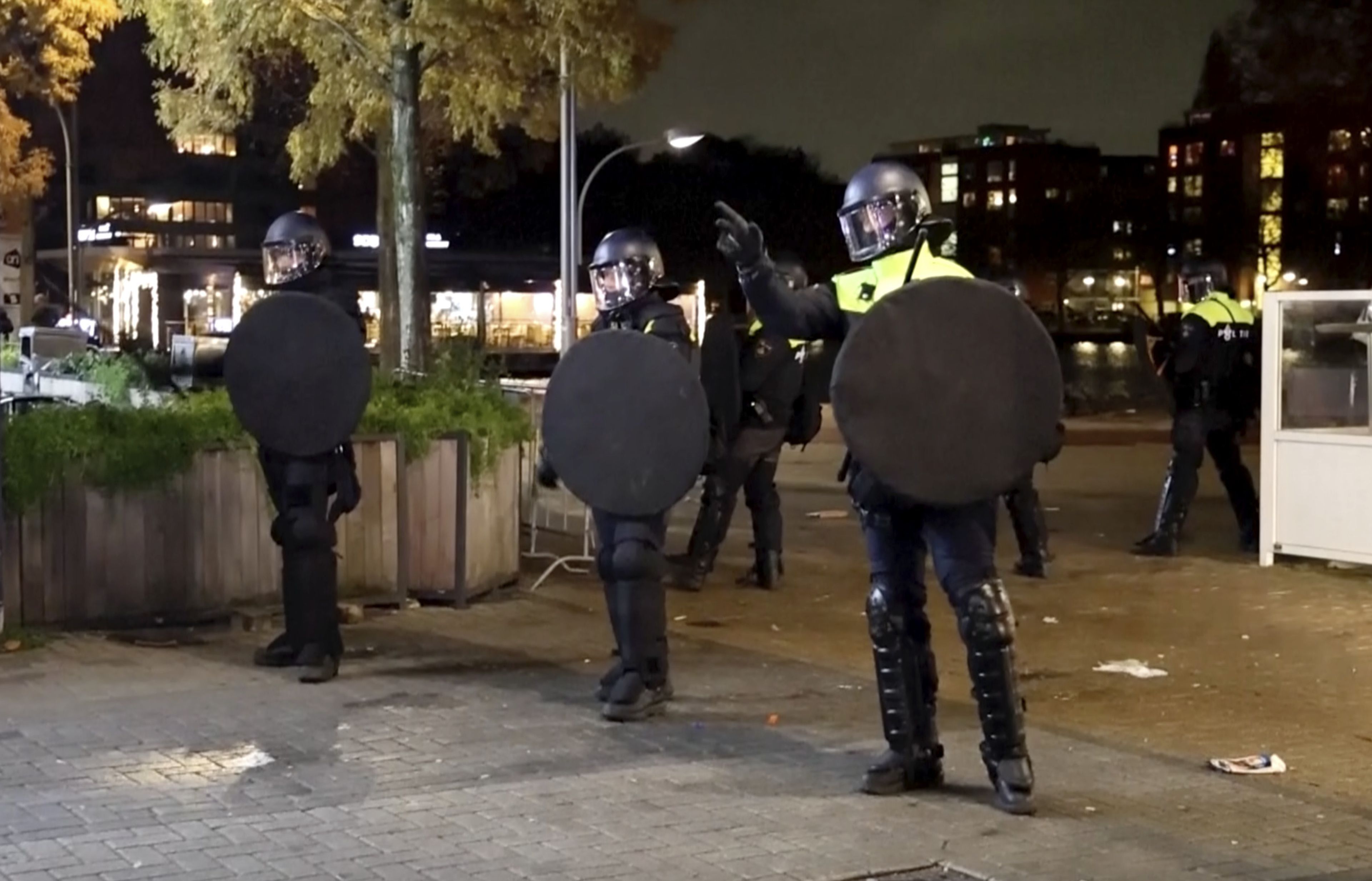 In this image taken from video, police officers patrol in riot gear on the streets of Amsterdam, Monday Nov. 11, 2024, as the city is facing tensions following violence last week. (AP Photo