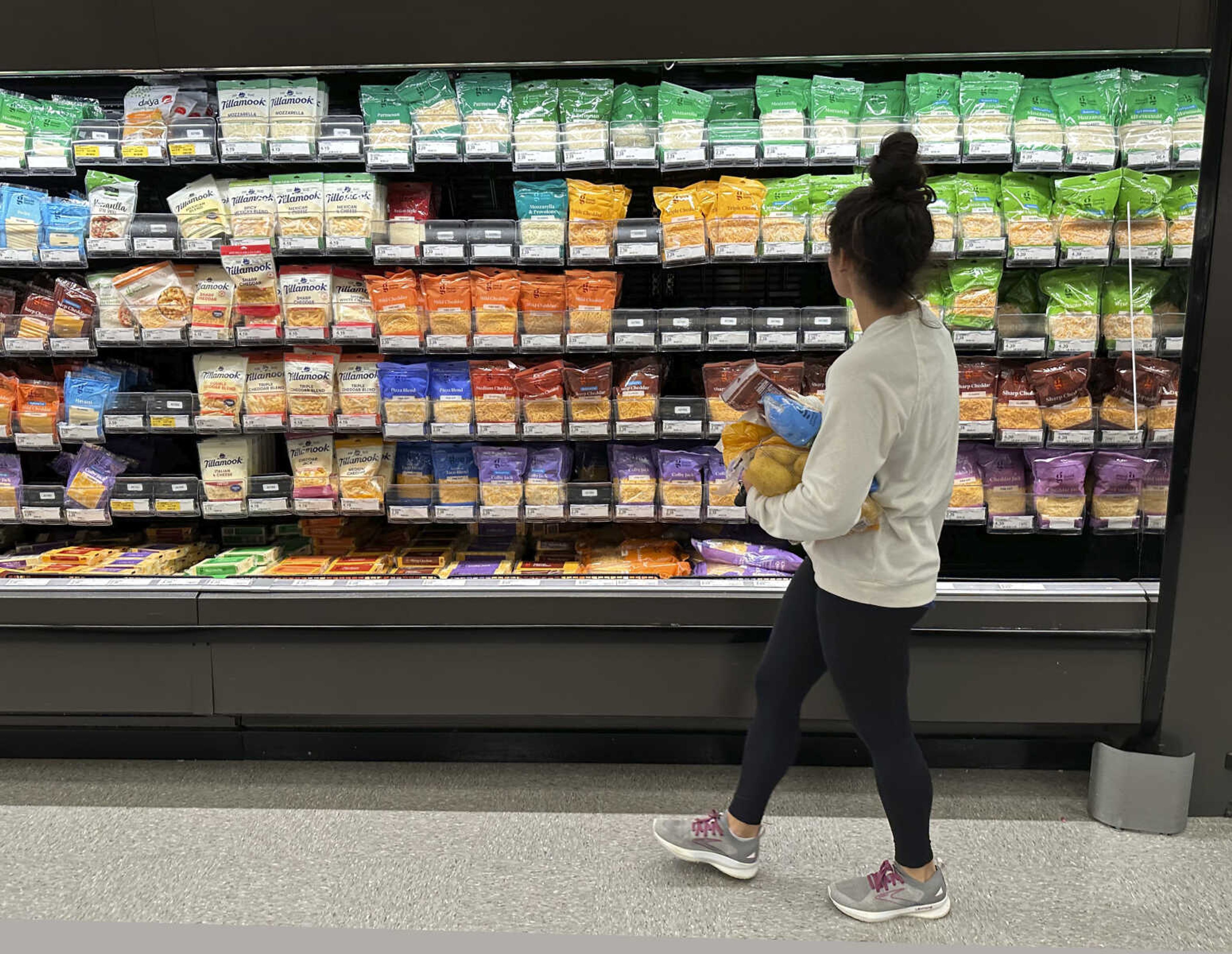 A shopper peruses cheese offerings at a Target store Oct. 4 in Sheridan, Colorado. As household expenses outpace earnings, many are expressing concern about their financial futures.