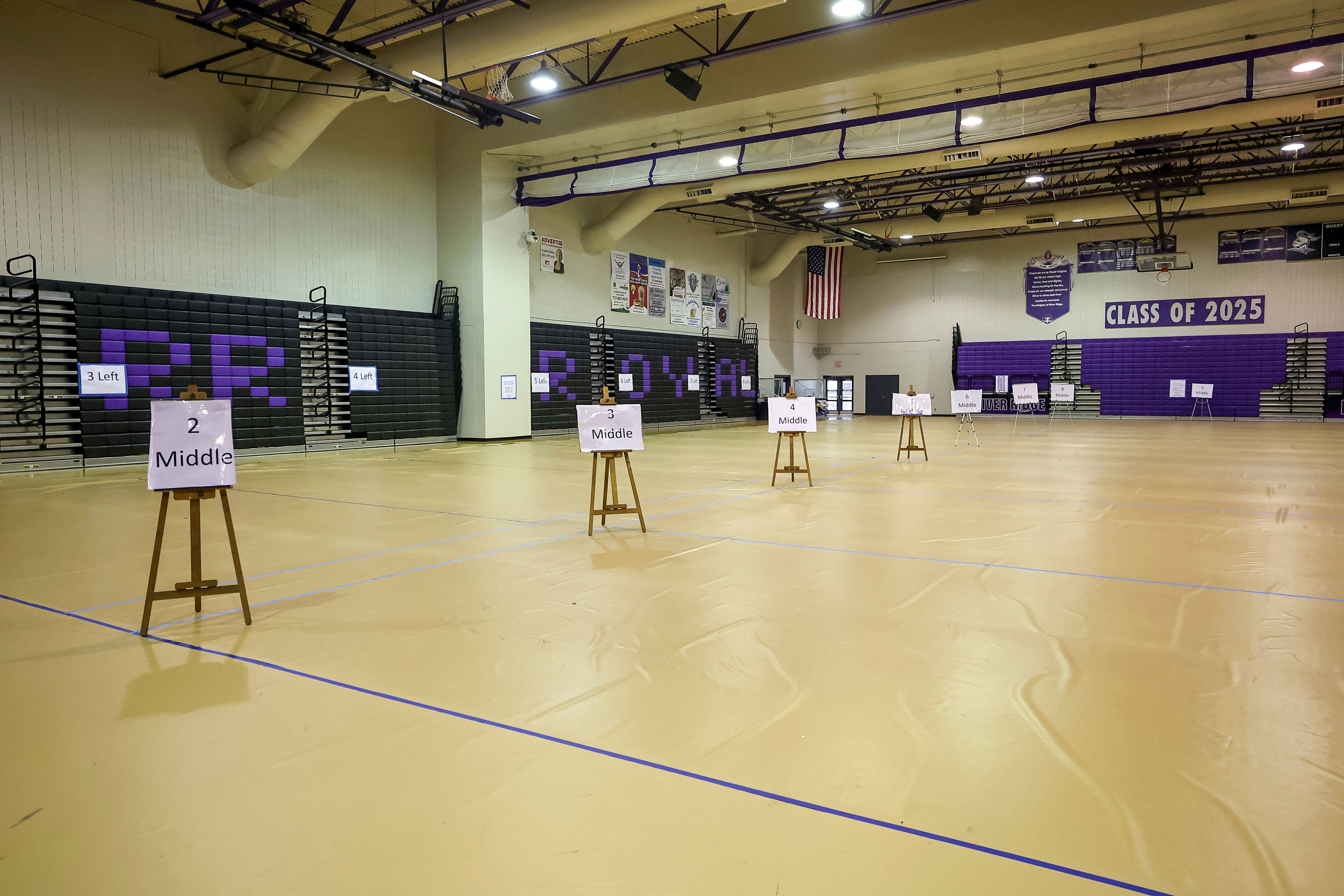 Flooring and signage is laid out at River Ridge High School as they ready the school for use as a shelter in preparation for Hurricane Milton on Monday, Oct. 7, 2024, in New Port Richey, Fla. (AP Photo/Mike Carlson)