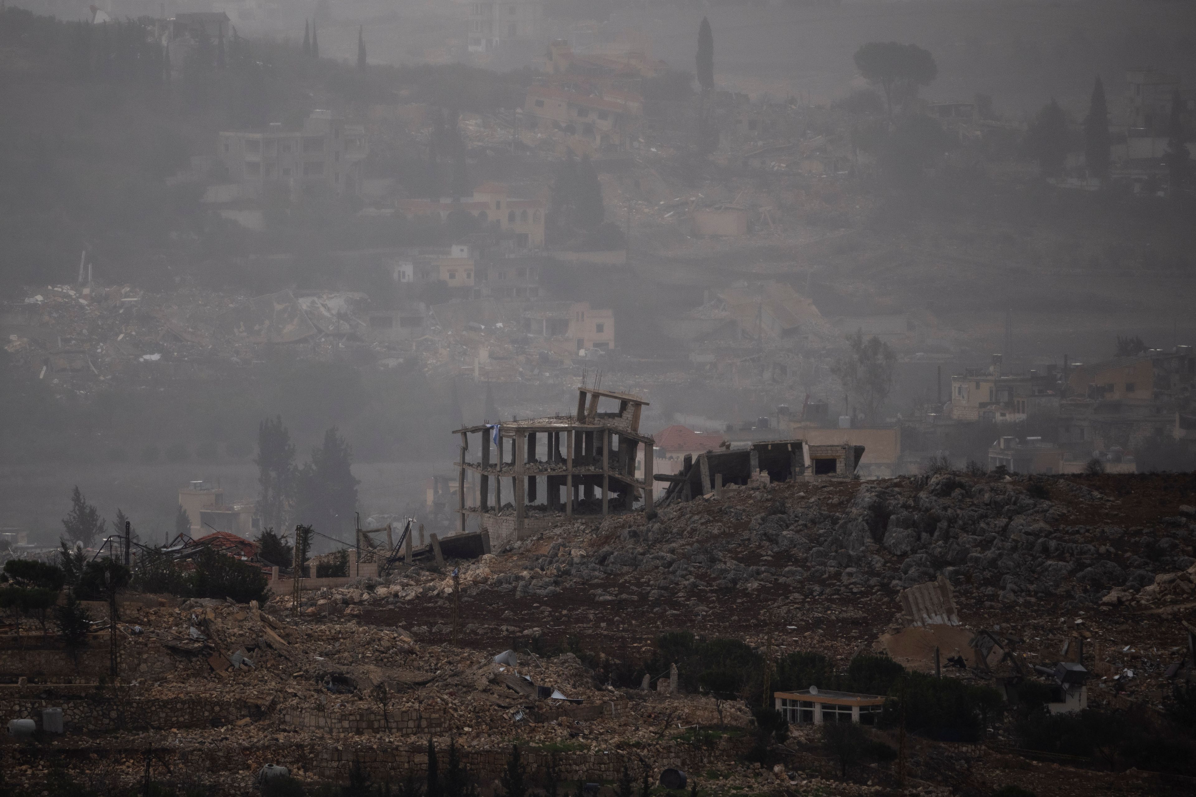 Destroyed buildings stand in the area of a village in southern Lebanon as seen from northern Israel, Monday, Nov. 25, 2024. (AP Photo/Leo Correa)