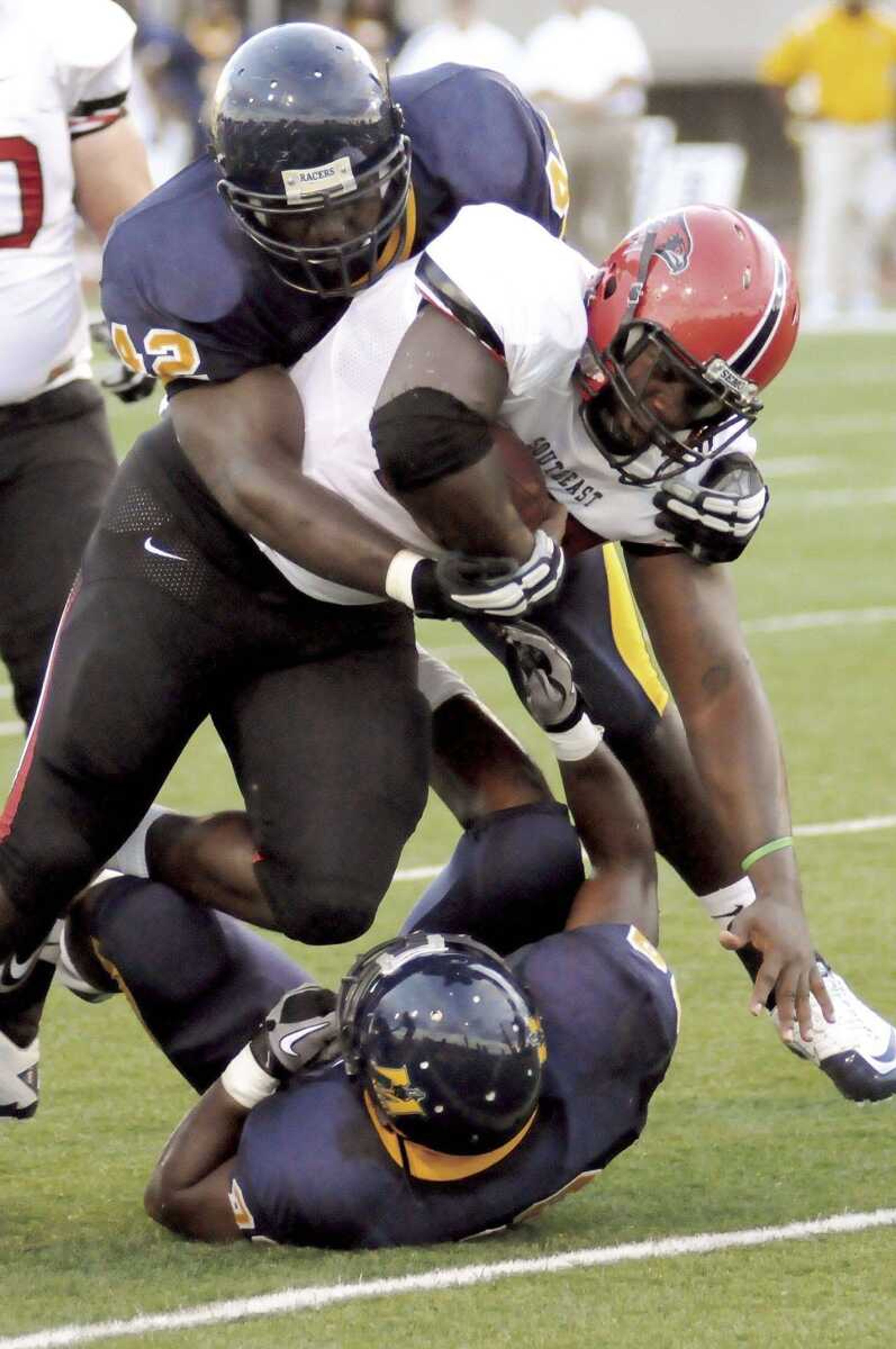 Southeast Missouri State's Mike Jones is tackled by Murray State's Arlester McKinnon, top, and Nick Moore during the second quarter of Saturday's game in Murray, Ky. (LANCE DENNEE ~ The Sun (Paducah, Ky.))