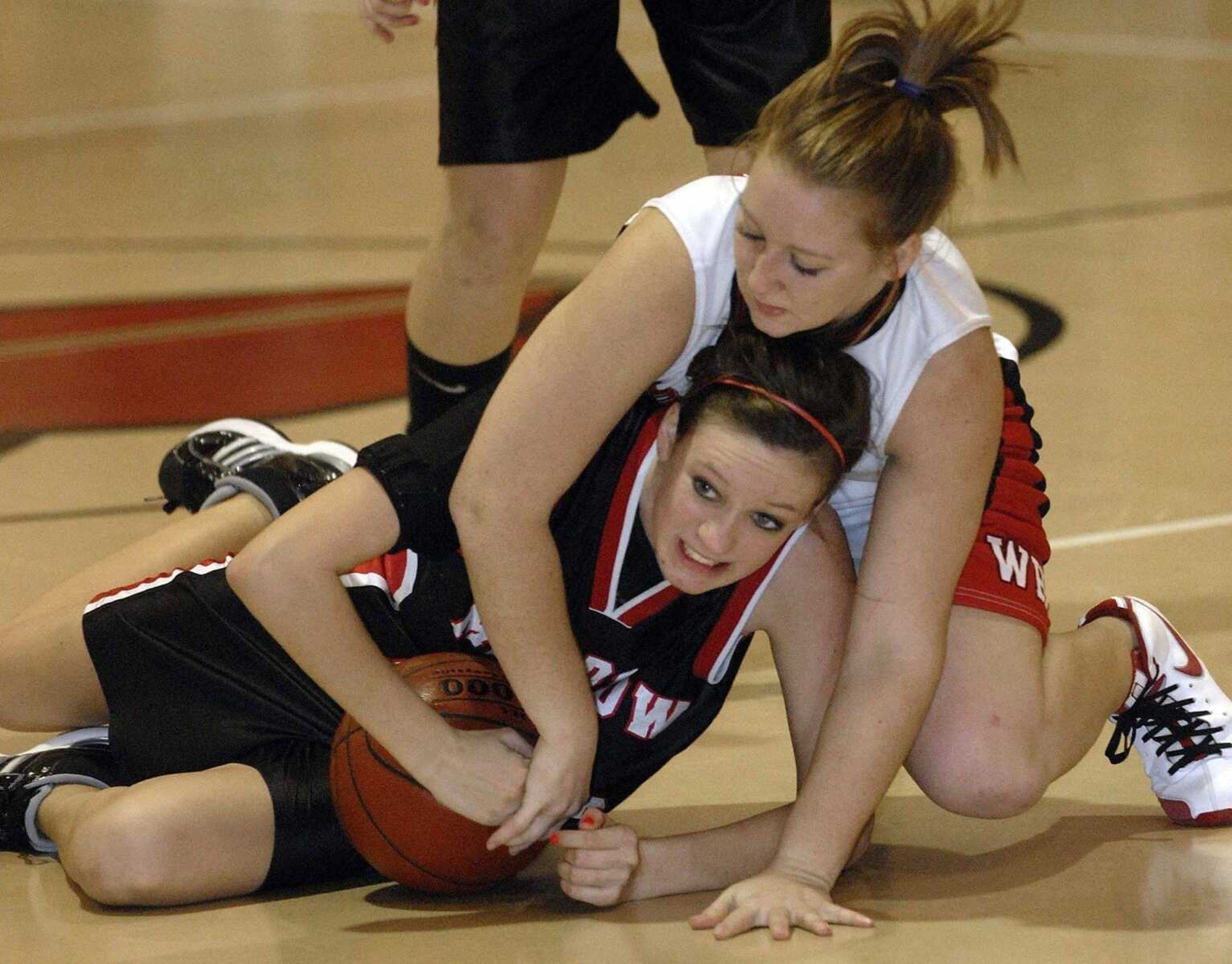 FRED LYNCH ~ flynch@semissourian.com<br>Meadow Heights' Heather Dietiker tries to keep the ball away from Woodland's Becky Brannon during the third quarter Thursday at Woodland.