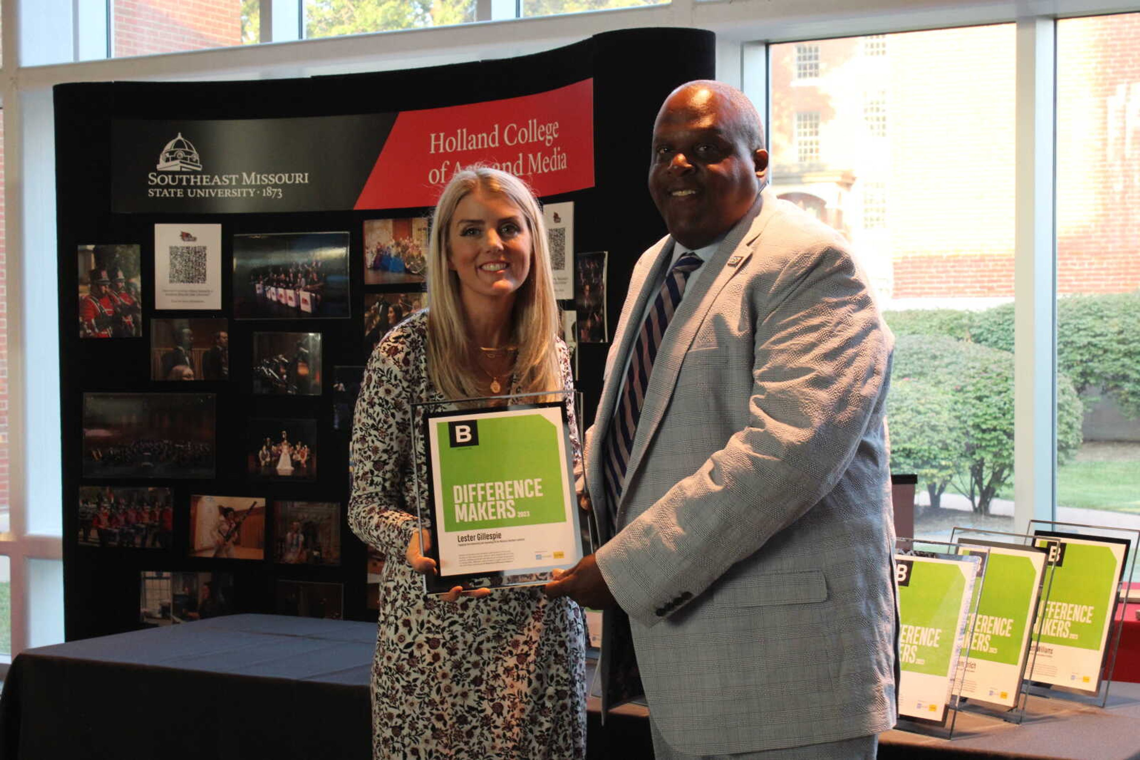 Edward Jones financial advisor Brooke Roth hands Difference Maker Lester Gillespie his award.