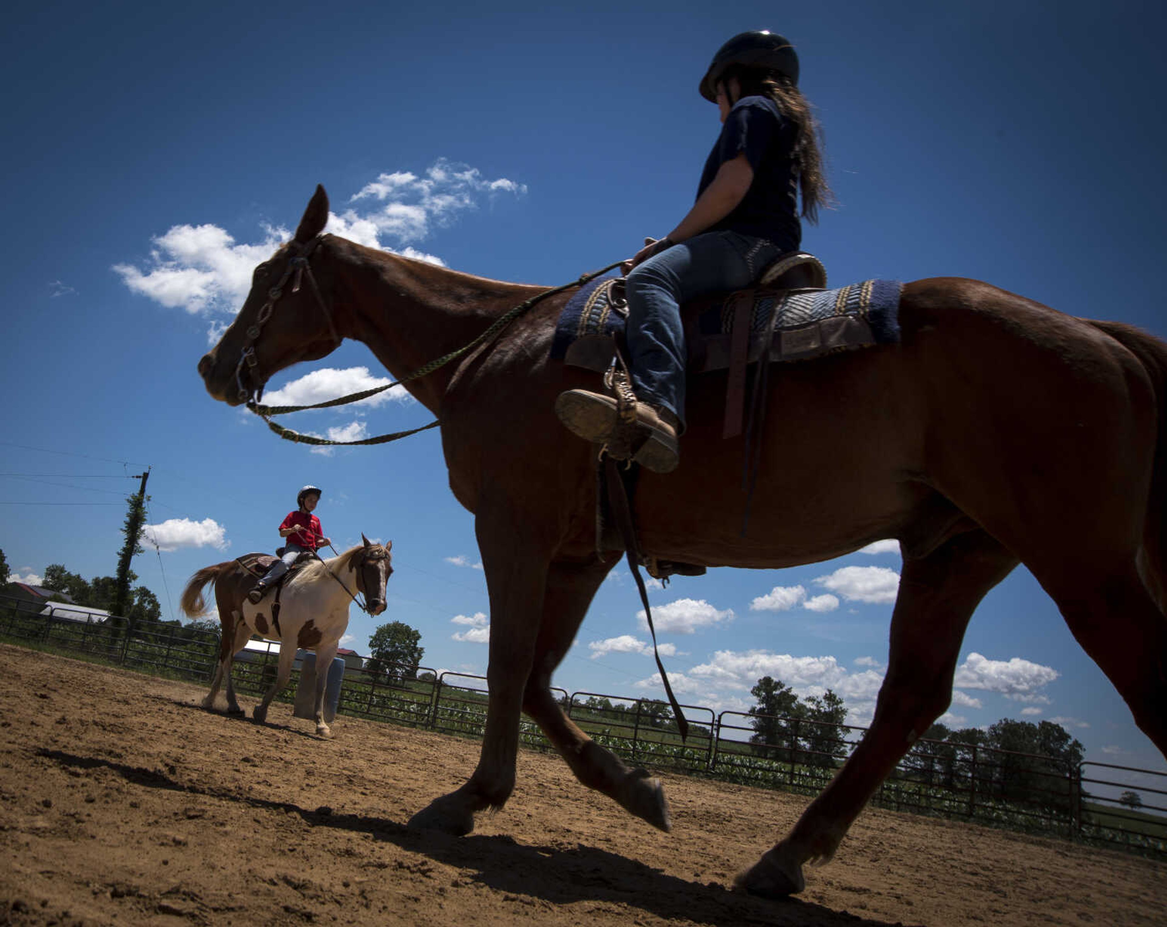 Kyleigh Coch, 11, left, and Emma Smith, 12, right, ride horses during the Rolling Hills Youth Day Camp Wednesday, June 7, 2017 in Cape Girardeau.