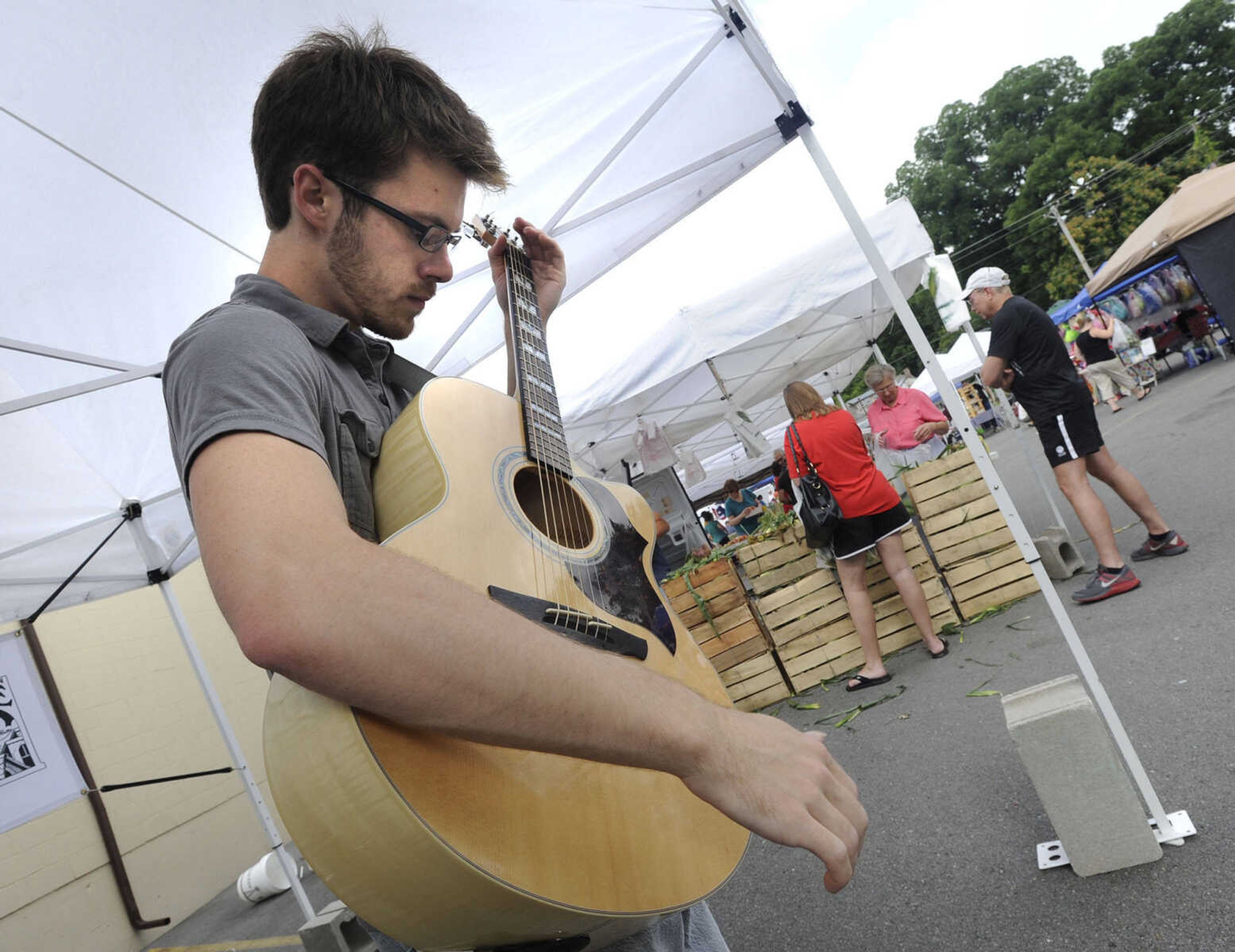 FRED LYNCH ~ flynch@semissourian.com
Jacob Seyer performs finger style and classical guitar music at the Cape Riverfront Market on Saturday, July 6, 2013 in Cape Girardeau.