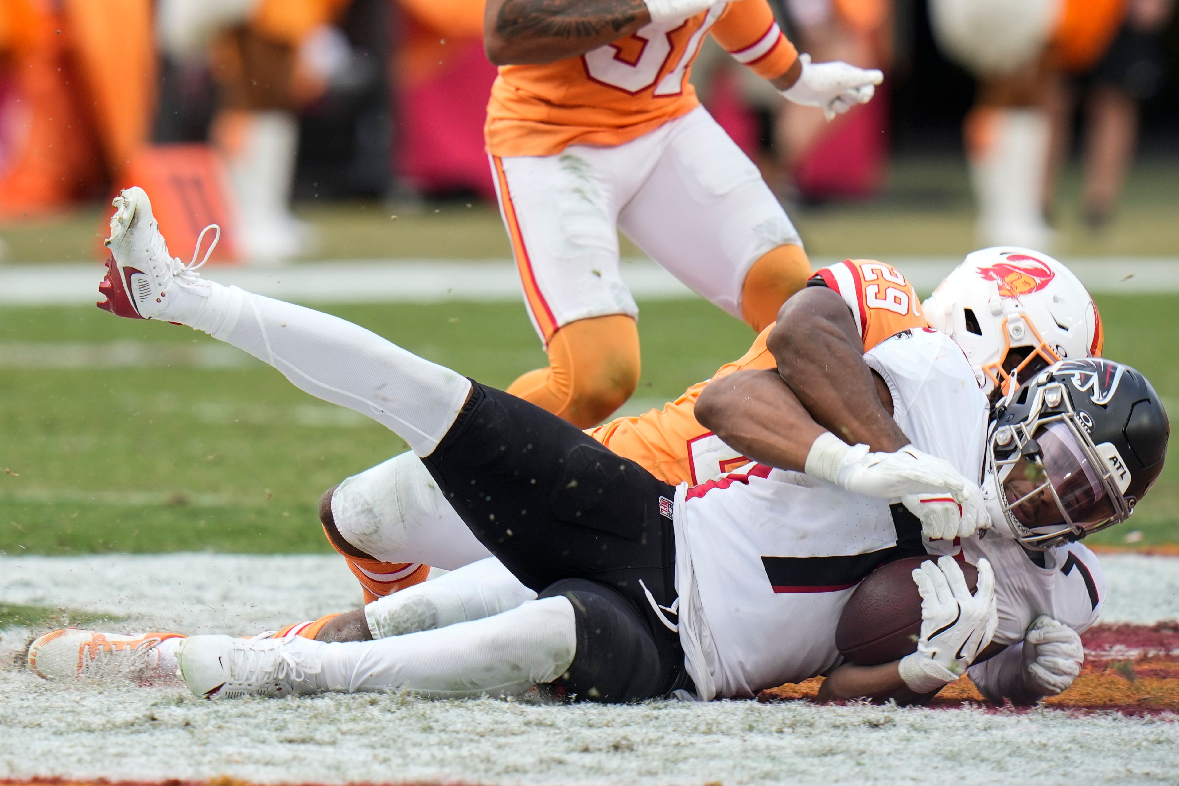 Tampa Bay Buccaneers cornerback Tyrek Funderburk (24) hits Atlanta Falcons running back Bijan Robinson (7) during the second half of an NFL football game, Sunday, Oct. 27, 2024, in Tampa. (AP Photo/Chris O'Meara)