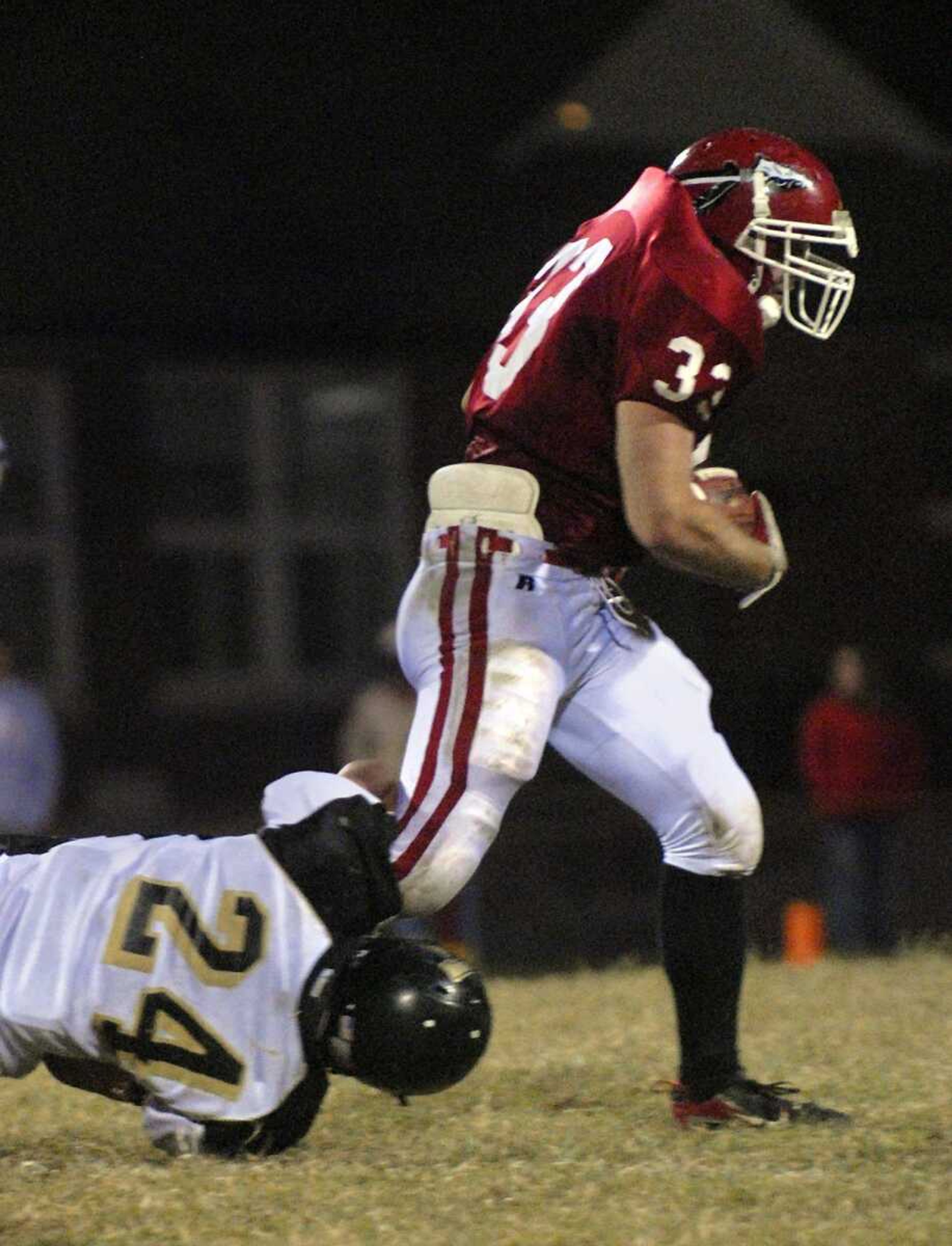 ELIZABETH DODD ~ edodd@semissourian.com
Jackson's Drew Bucher, right, attempts to shake free from the grip of Farmington's Korde Detring during the second quarter Friday at Jackson. Farmington defeated Jackson 42-38.