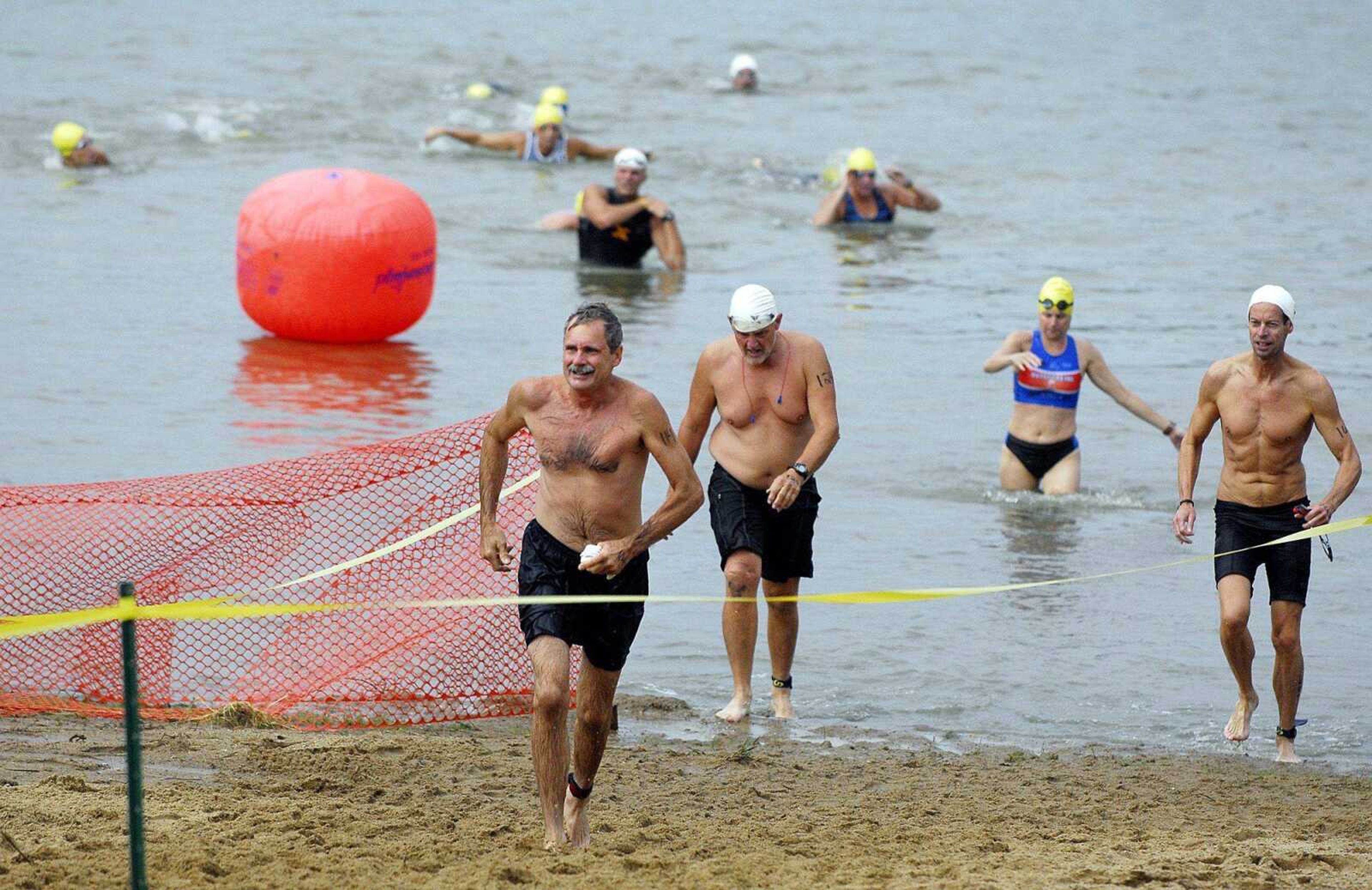 Competitors exit Lake Boutin during the swimming portion of the Trail of Tears triathlon Saturday. (Laura Simon)