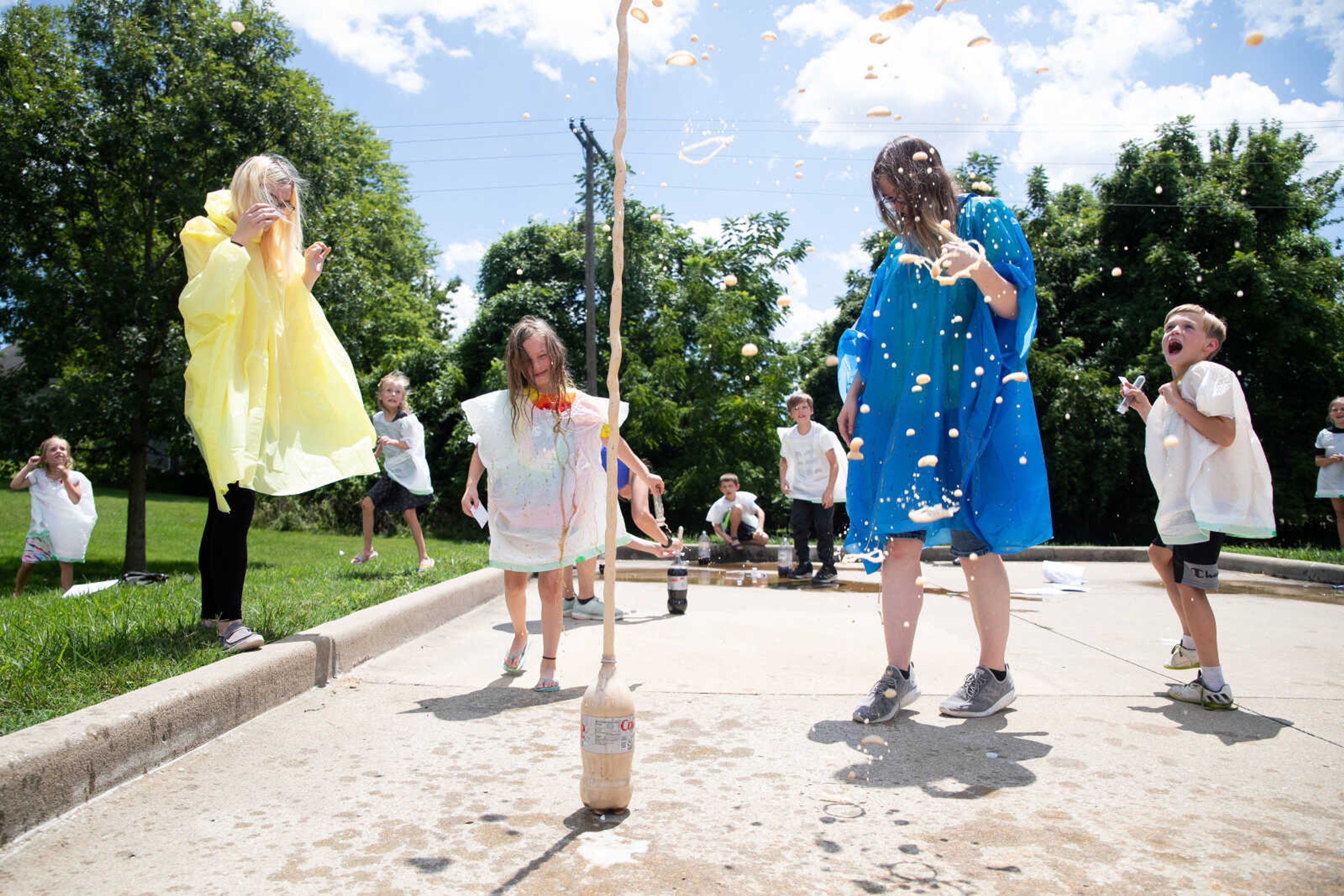 Twins Olivia and Allison Majors, 18, react as&nbsp;Tessa&nbsp;Behring, 6, erupts her Coke bottle in an experiment.