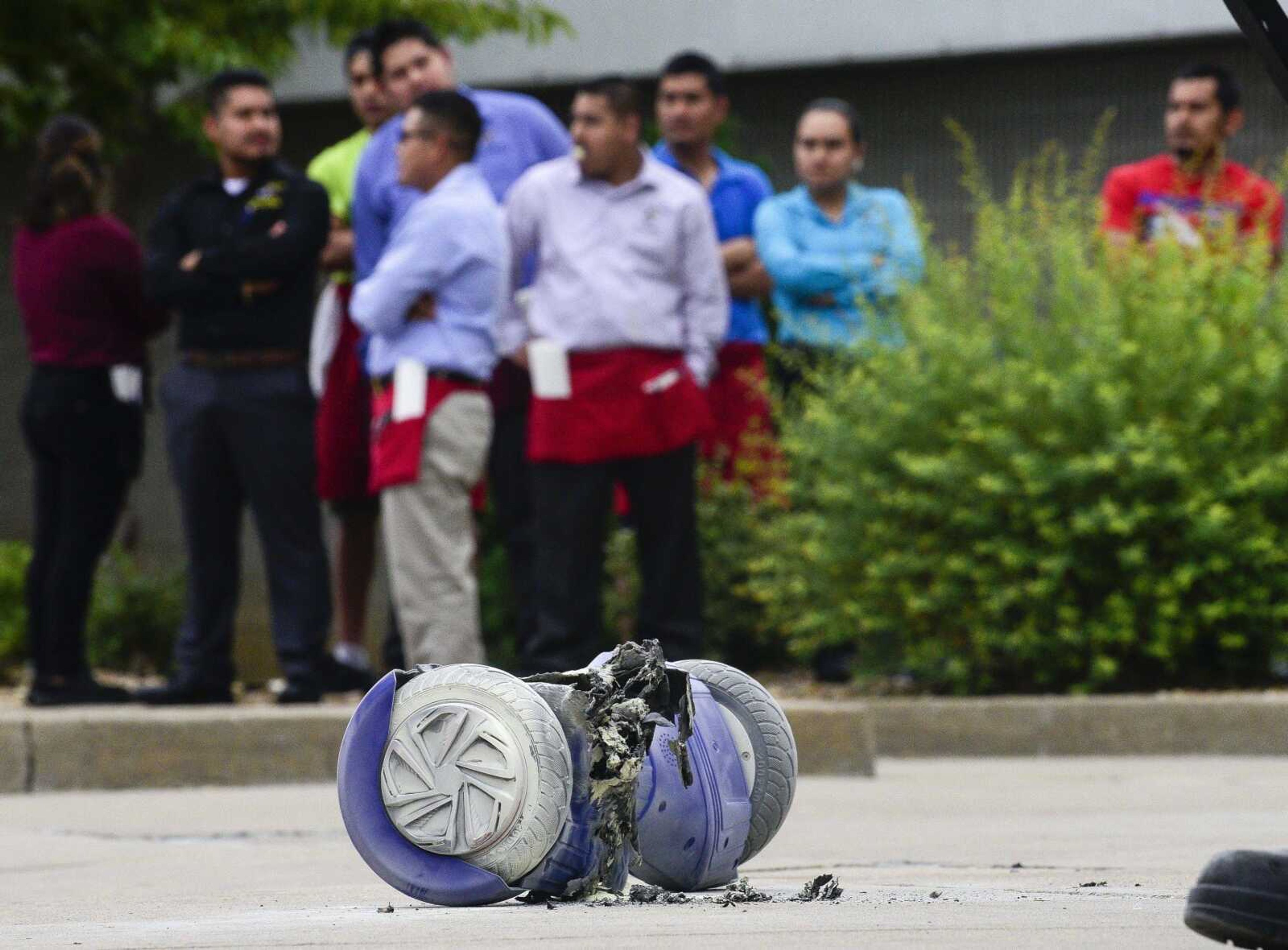 Shoppers wait outside of the West Park Mall on Saturday evening after an evacuation prompted by a hoverboard fire.